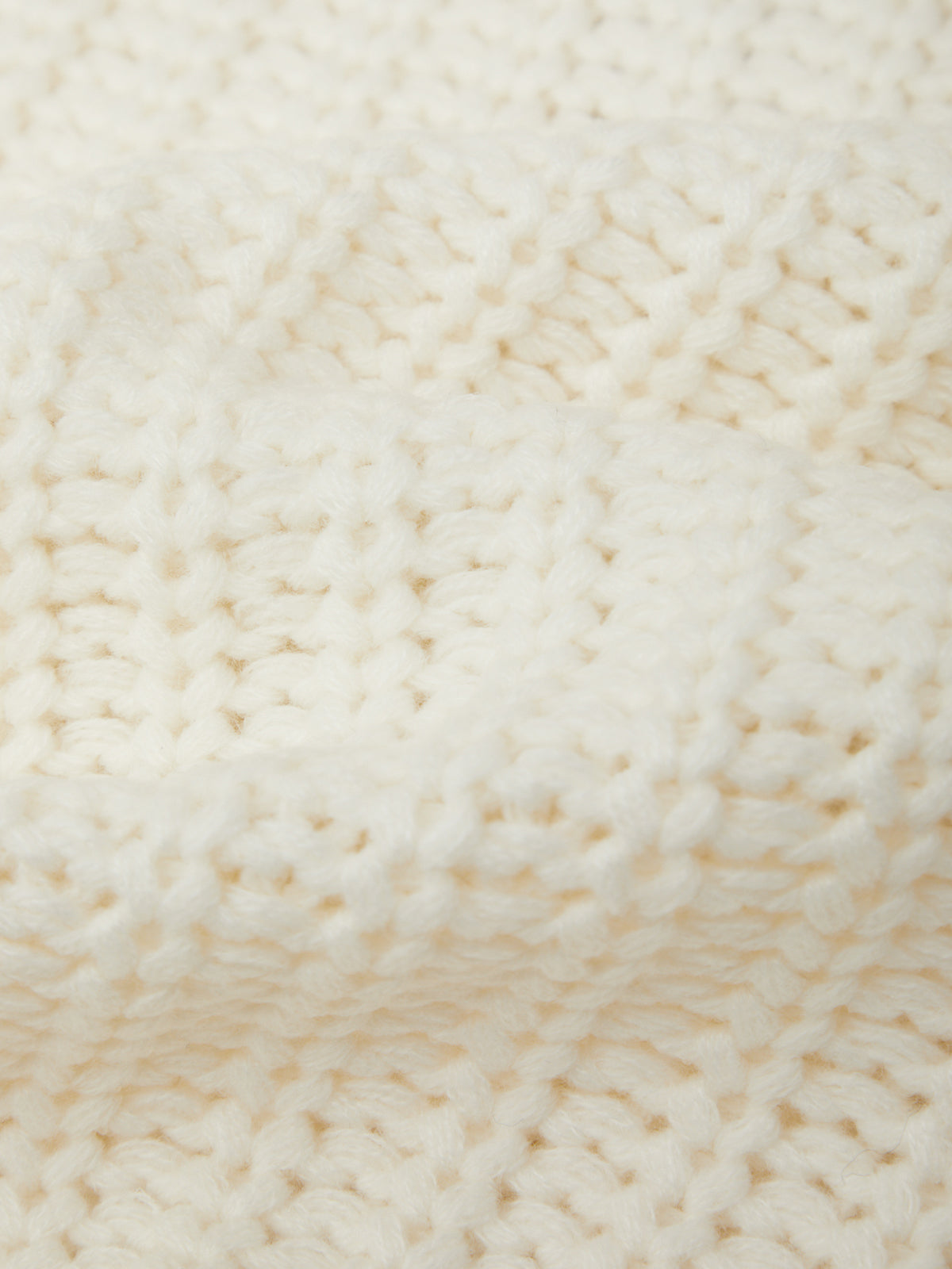 Close-up of a textured beige fabric surface
