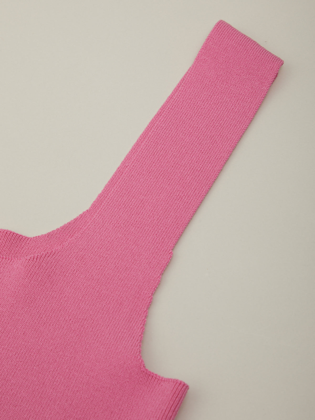 Close-up of a pink sleeveless top on a light gray background