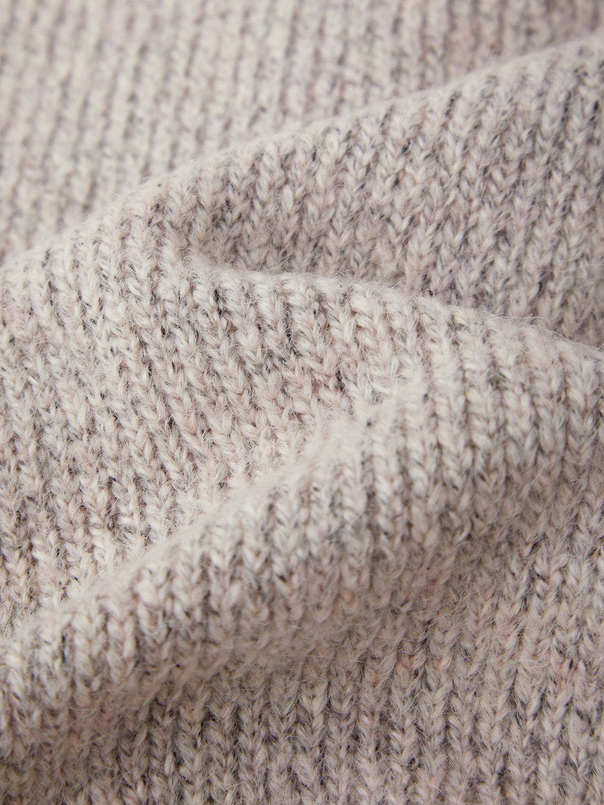 Close-up of textured beige fabric with a subtle pattern