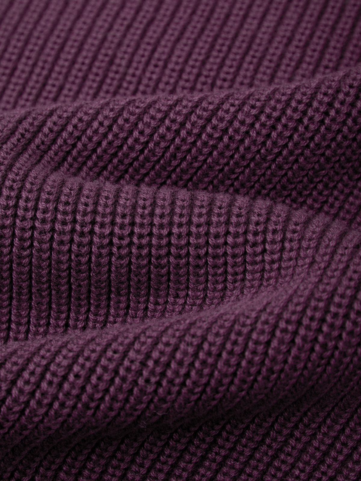 Close-up of a textured purple fabric with a ribbed pattern