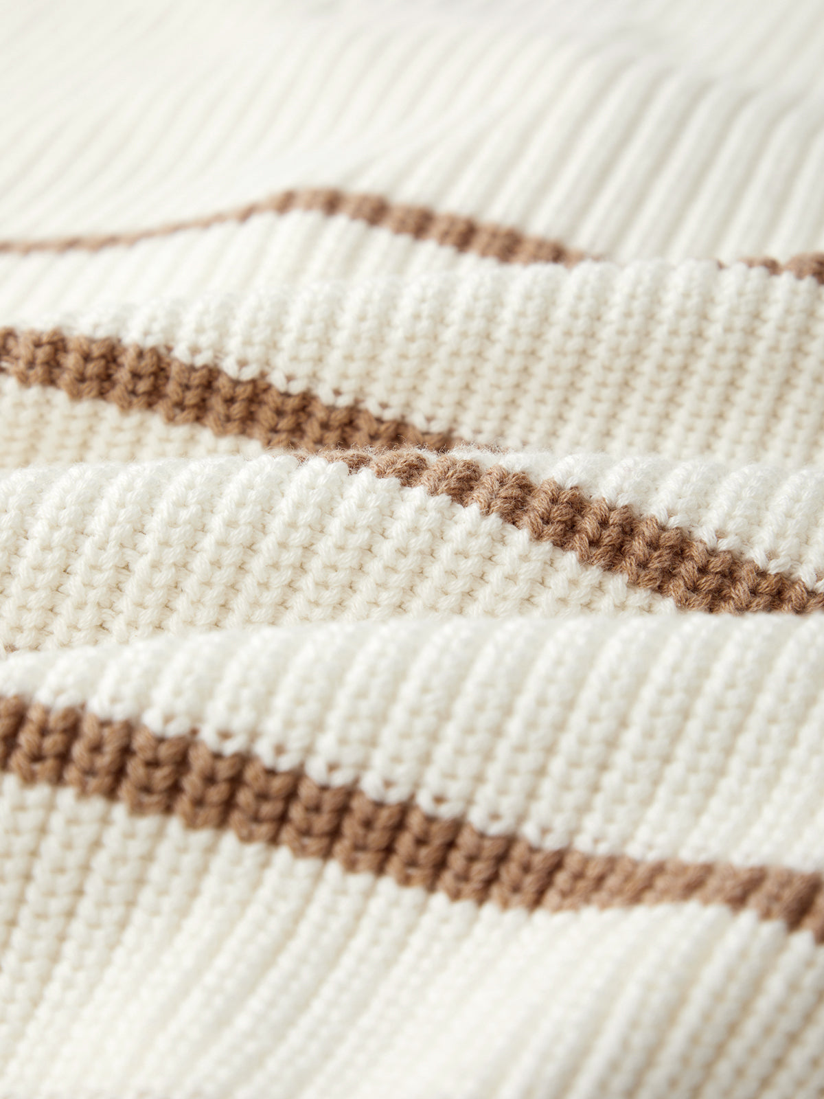 Close-up of a 100% cotton knitted fabric by 525 America, showcasing alternating cream and brown horizontal stripes with a ribbed texture.