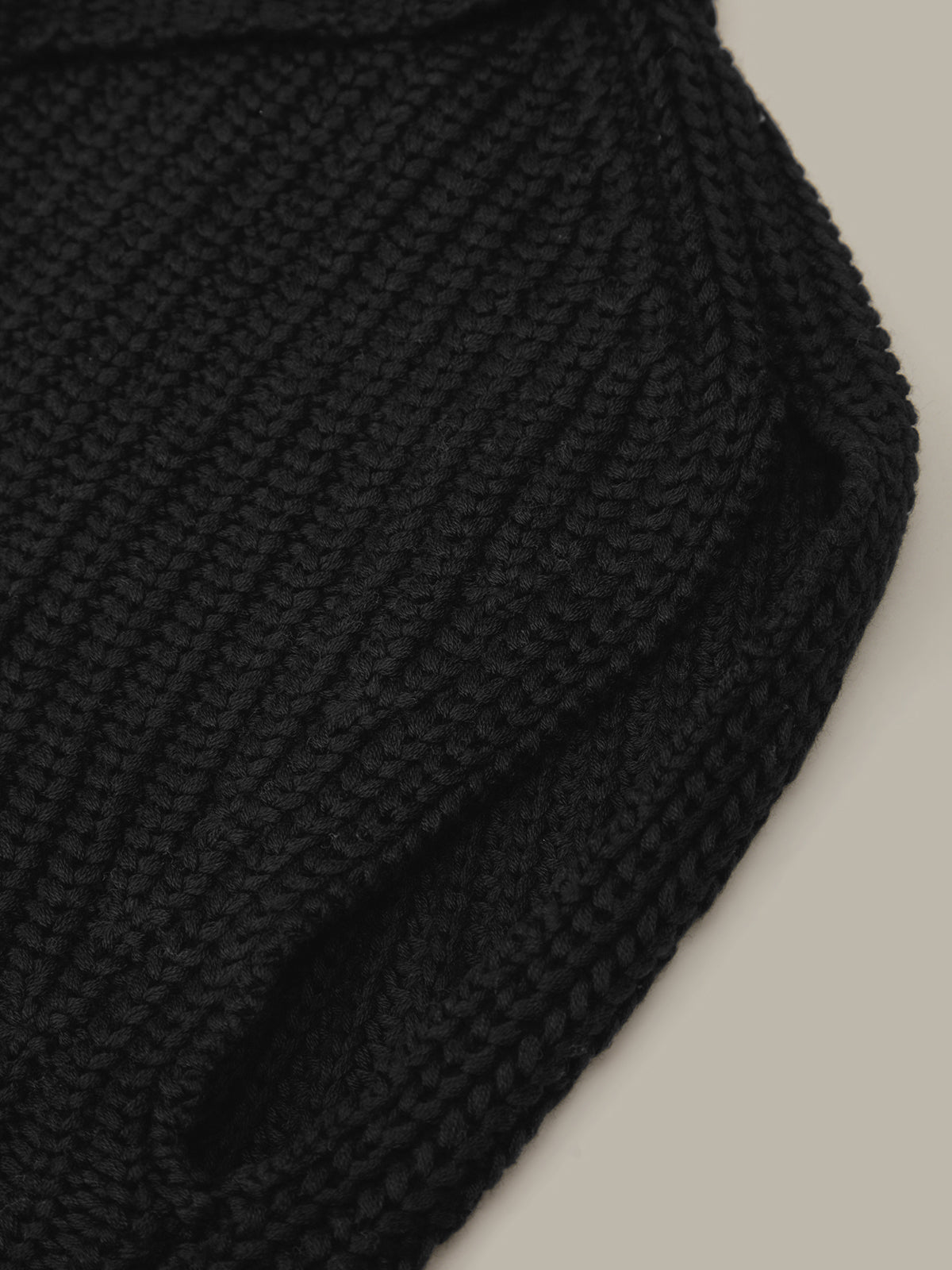 Close-up of a textured black fabric on a light gray background