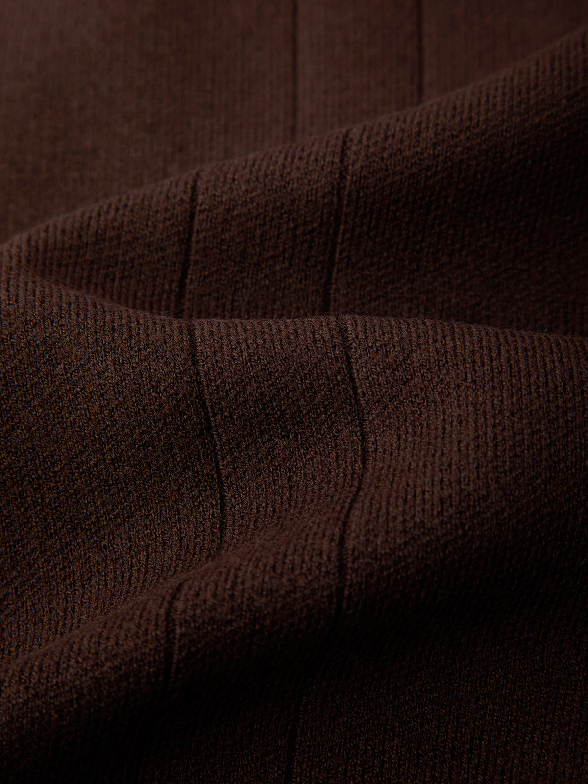 Close-up of brown textured fabric with visible stitching