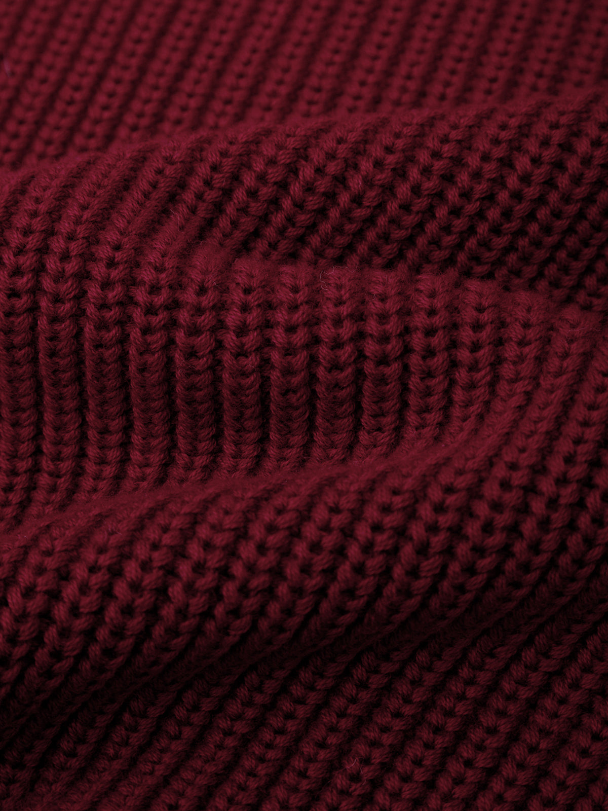 Close-up of a textured red fabric with a waffle pattern
