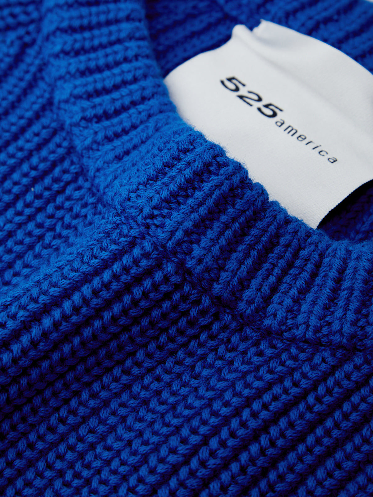Close-up of a blue textured fabric with a white label displaying '525 america'.