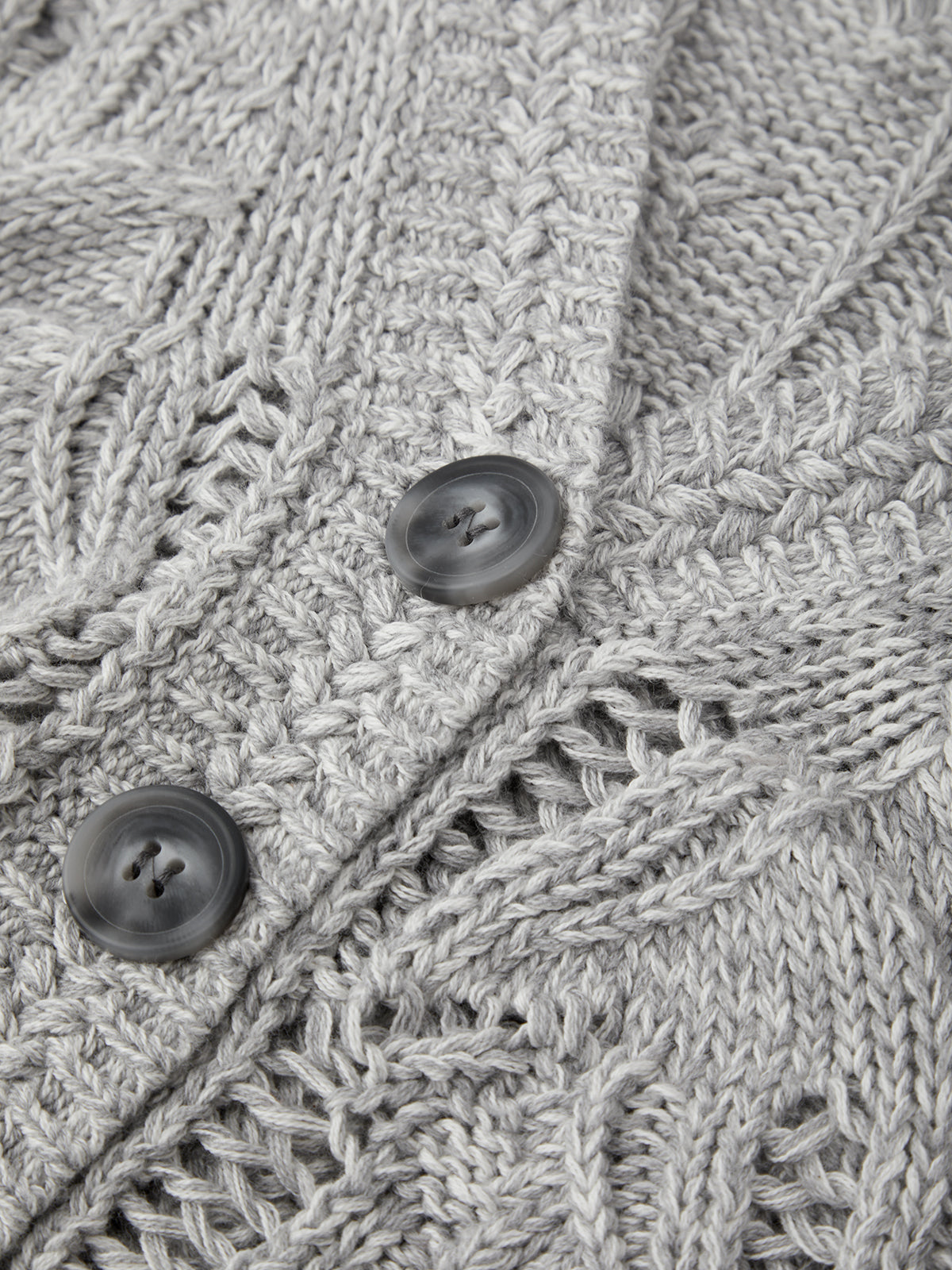 Close-up of a textured gray fabric with button details