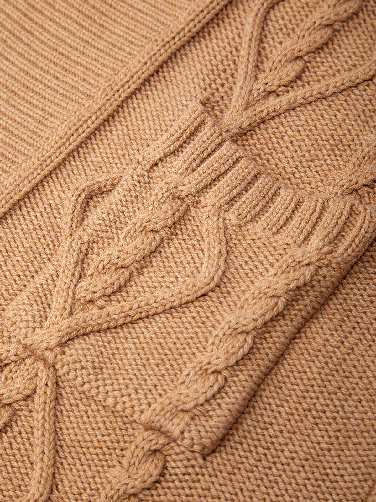Close-up of a brown knitted fabric with cable pattern