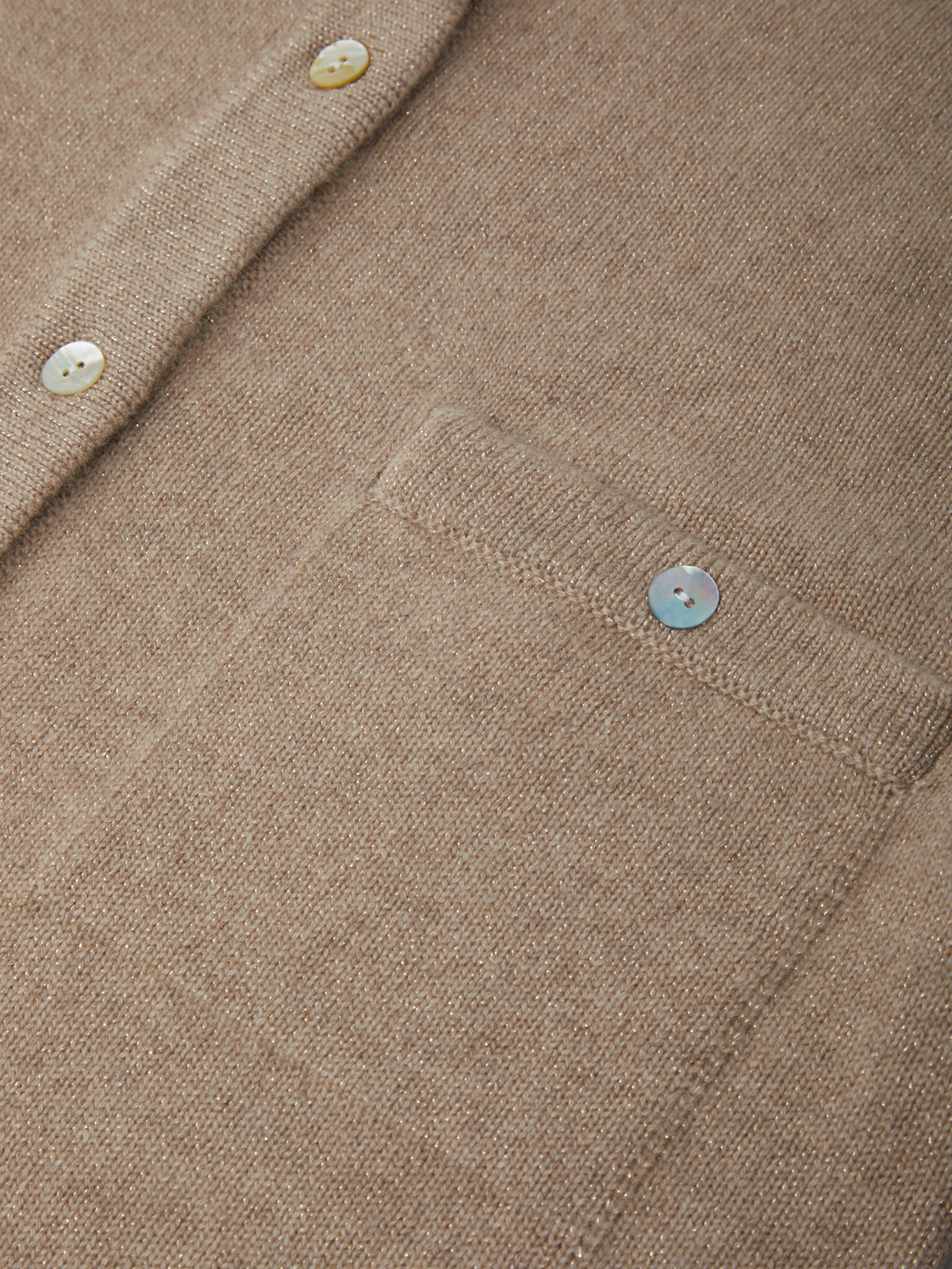Close-up of a beige textured fabric with buttons