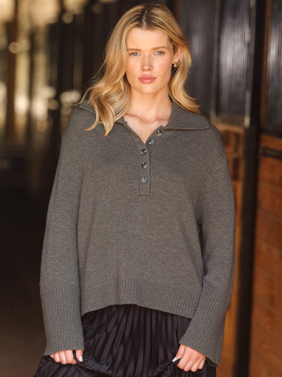 Woman wearing a gray sweater with a blurred background