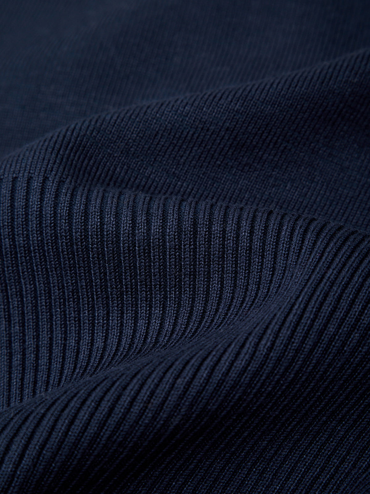 Close-up of dark blue ribbed fabric texture
