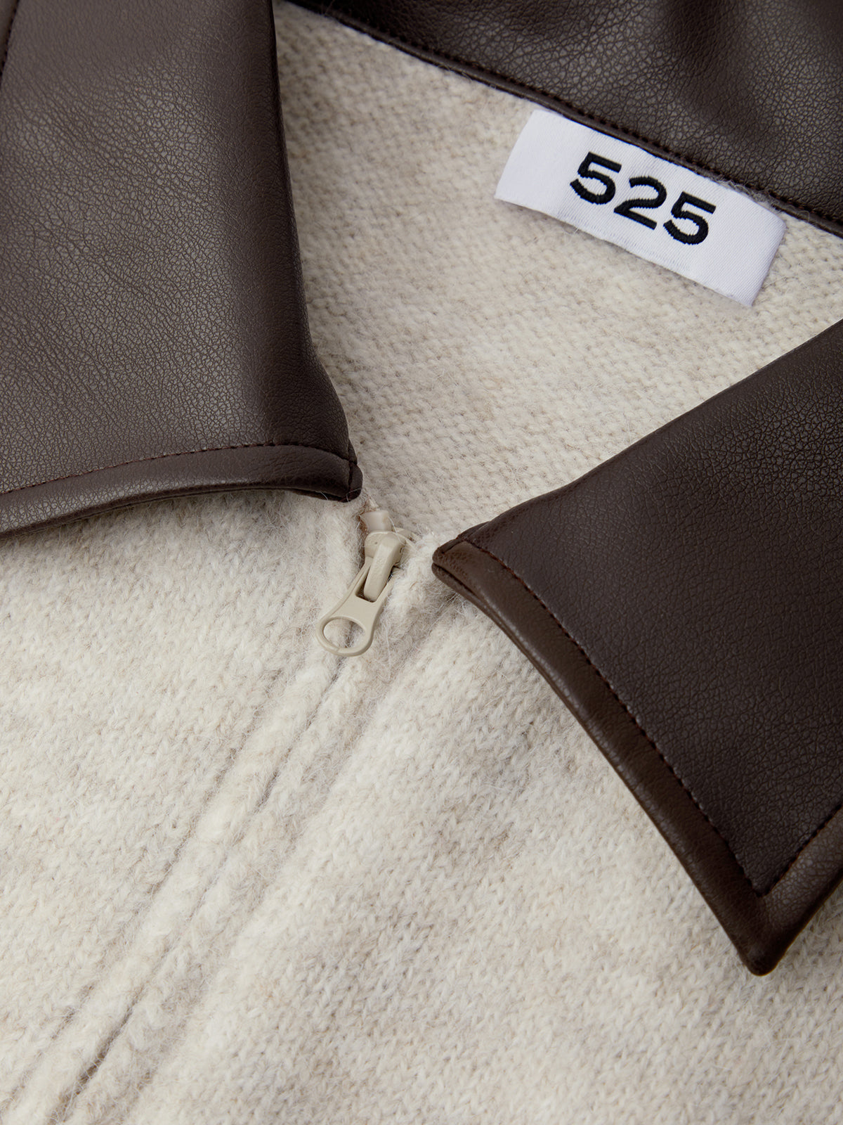 Close-up of a jacket with a visible brand label on a textured fabric background