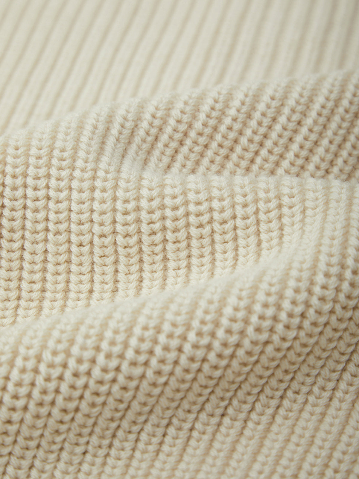 Close-up of beige knitted fabric texture