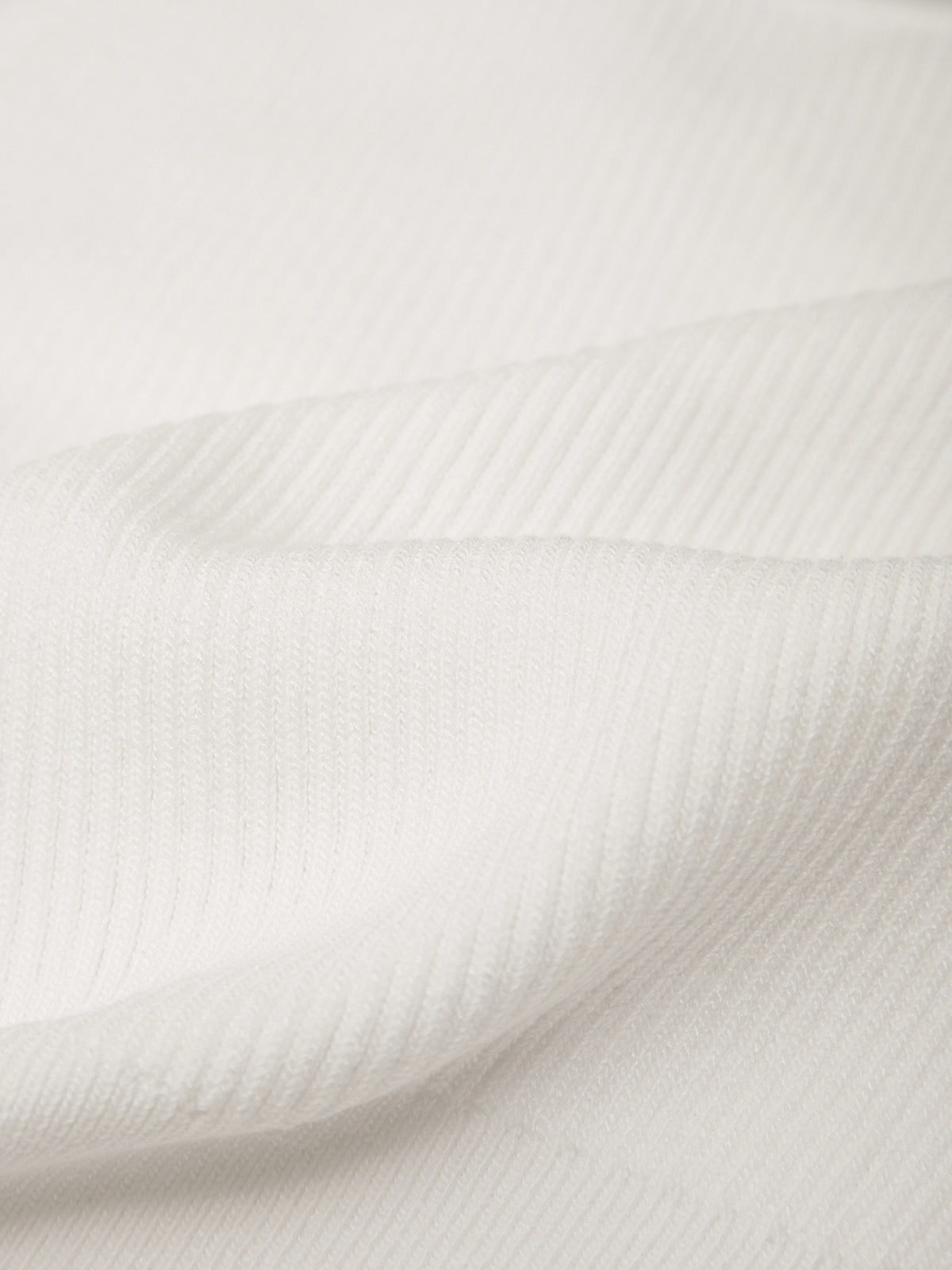 Close-up of white fabric with a subtle pattern