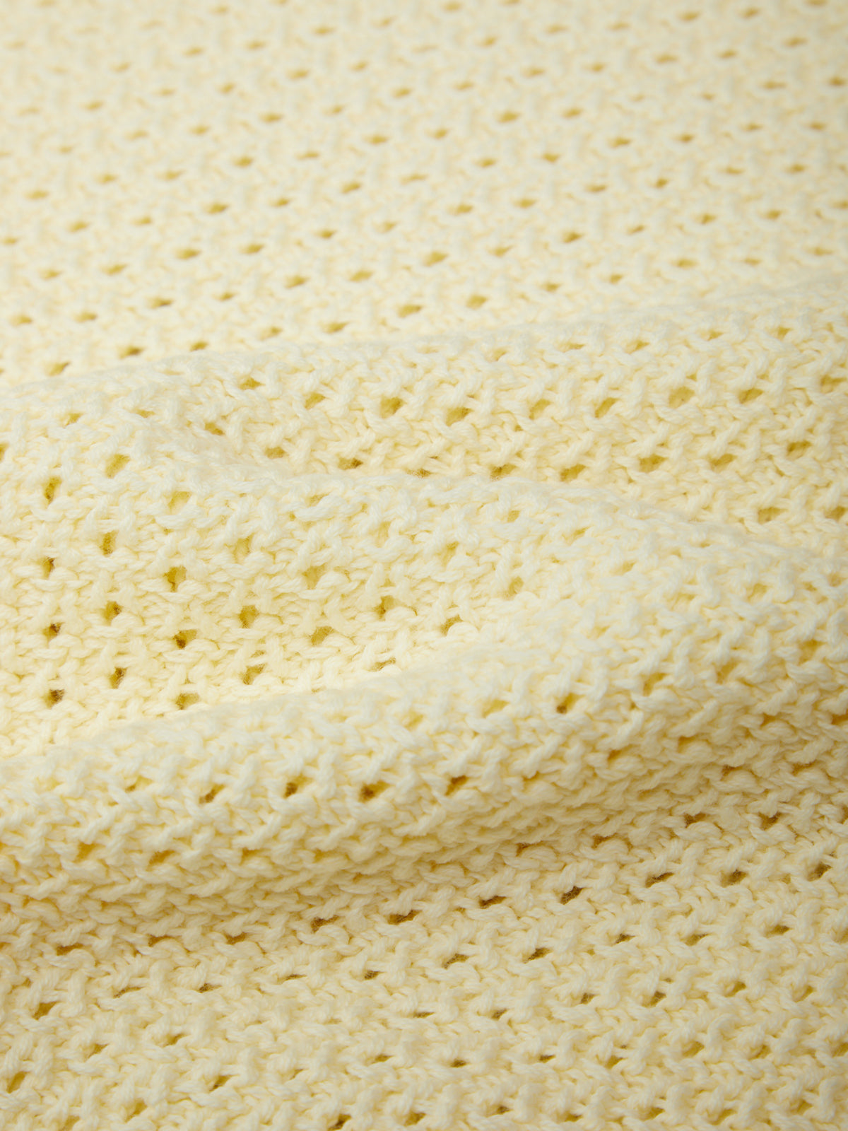 Close-up of a textured beige fabric with a subtle pattern