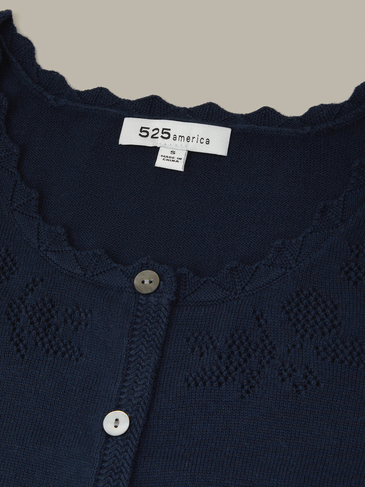 Navy blue cardigan with lace detailing and '525 america' label.