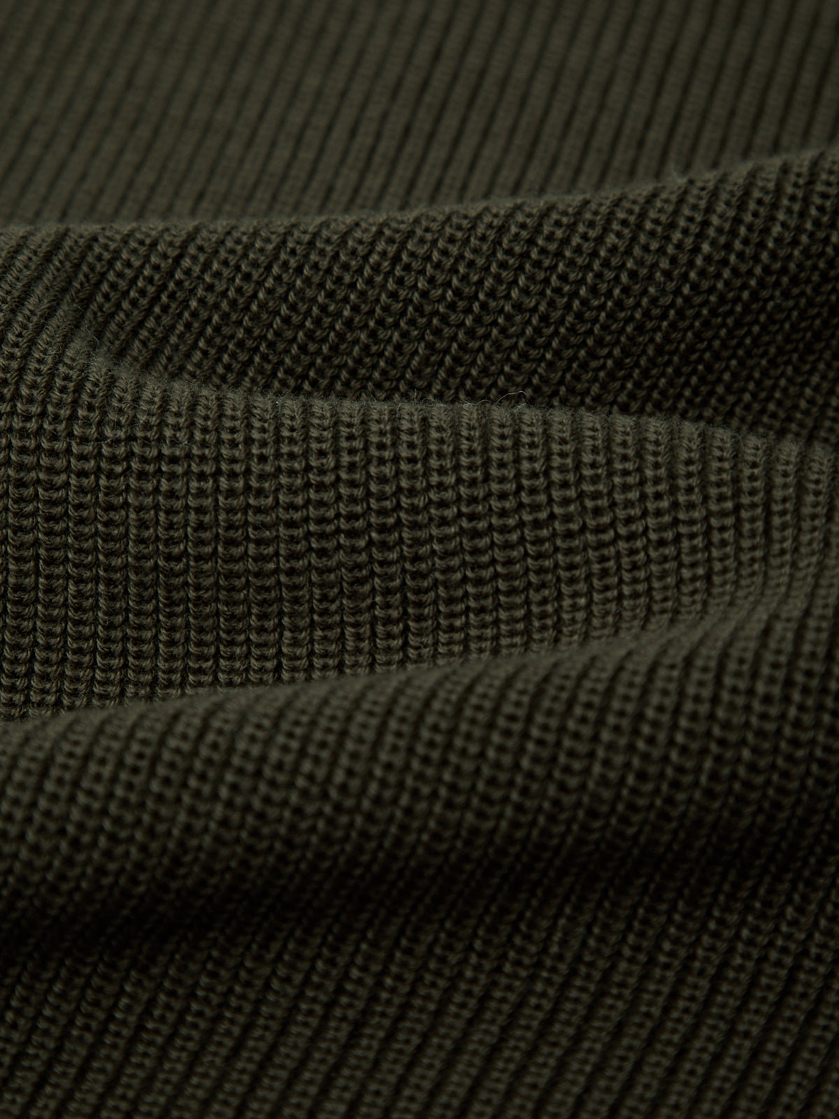 Close-up of dark green fabric texture