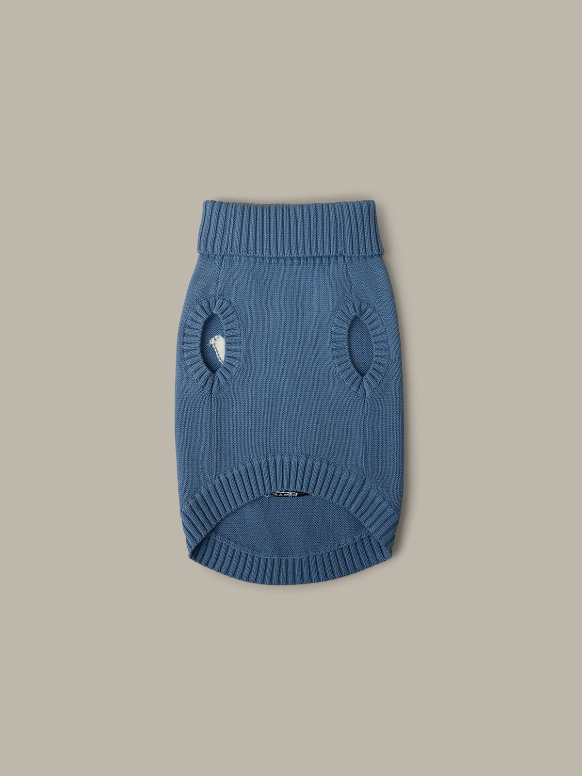 Blue knitted dog sweater on a beige background