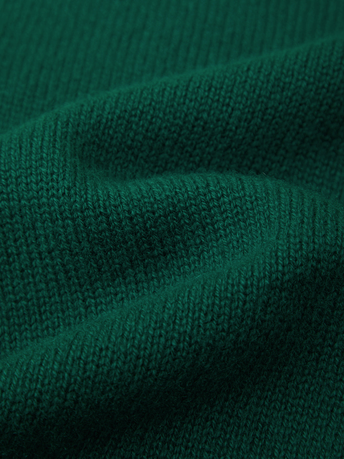 Close-up of dark green fabric texture