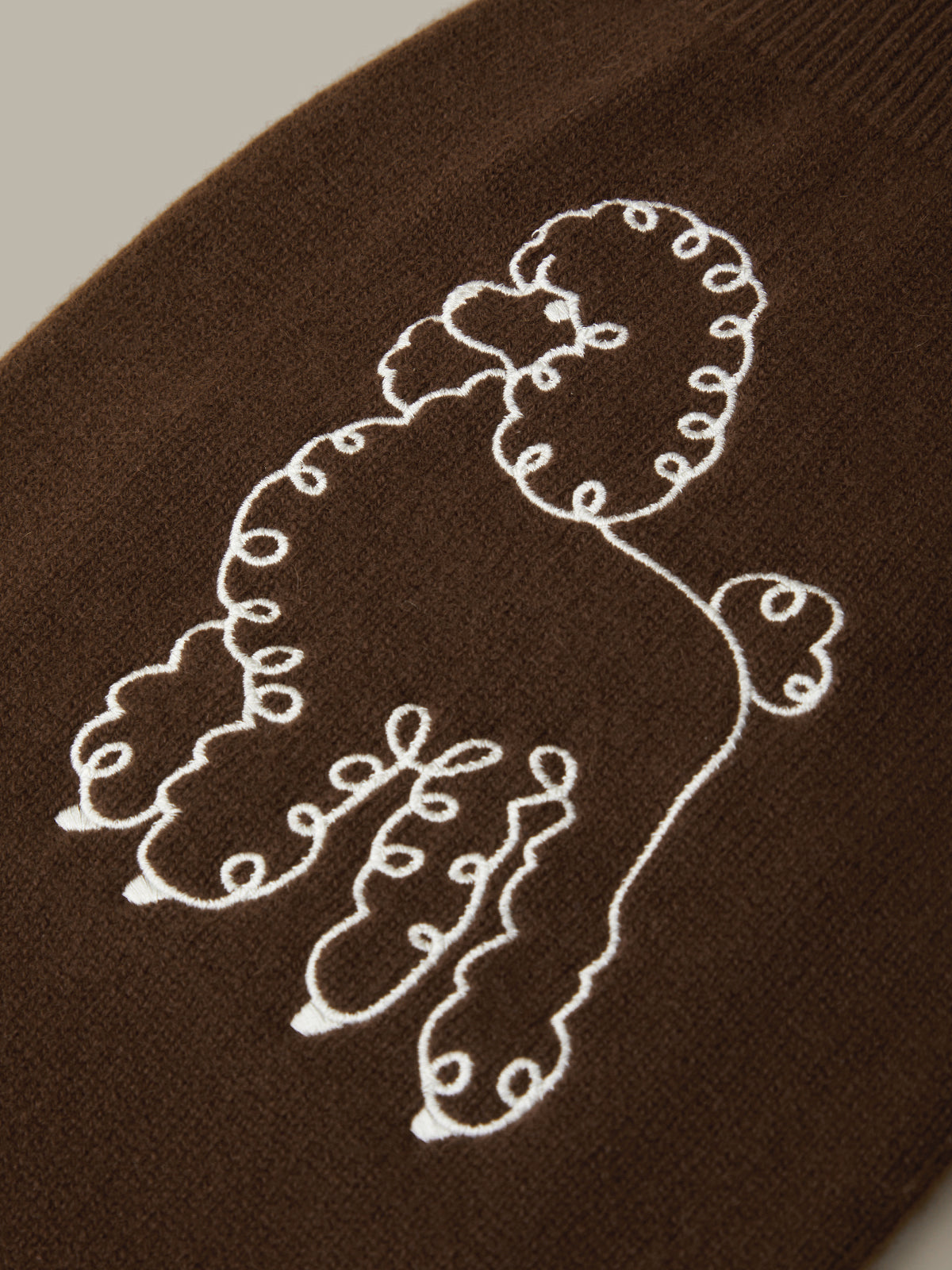 Embroidered design on a brown fabric background