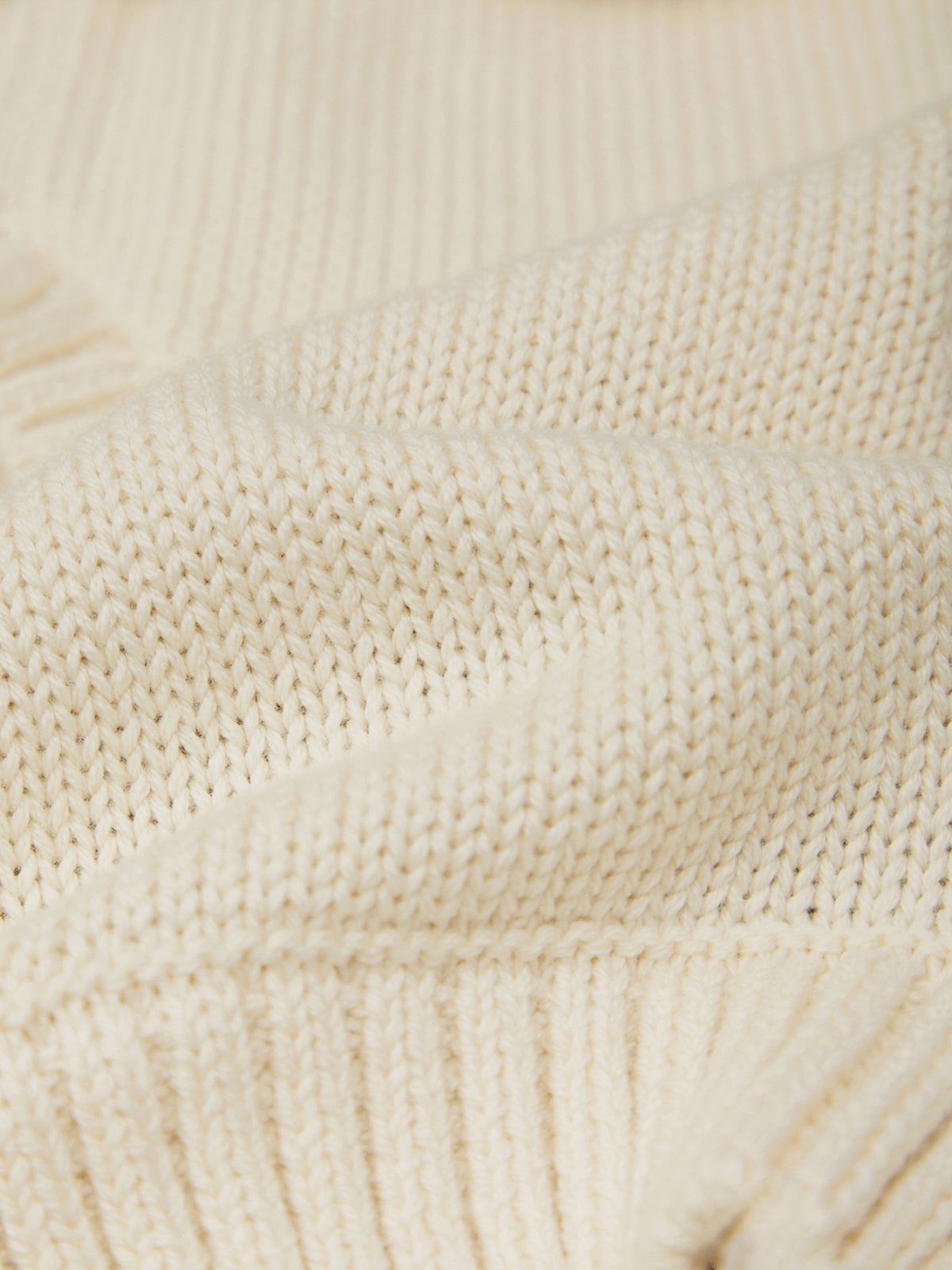 Close-up of a textured beige fabric surface