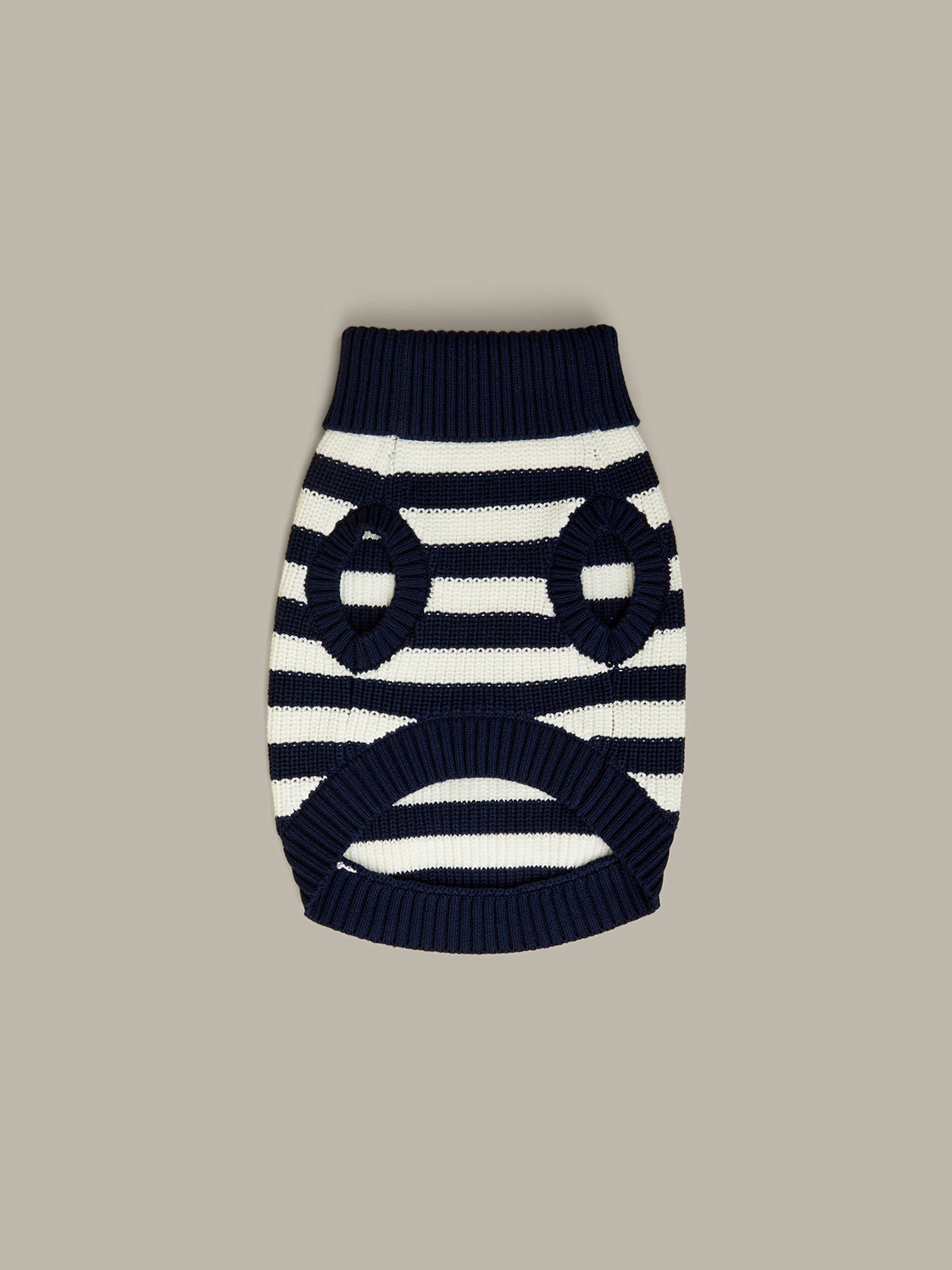 Navy and white striped dog sweater on a beige background