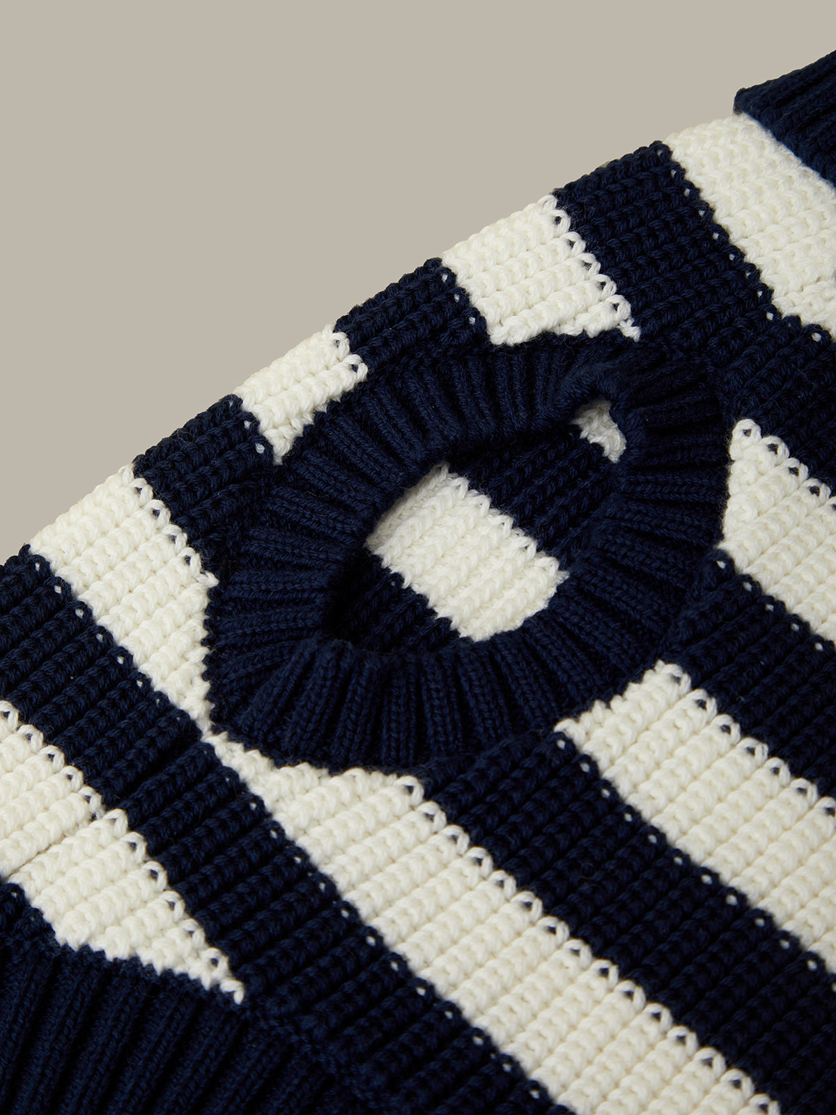 Close-up of a navy and white striped fabric with a circular pattern.