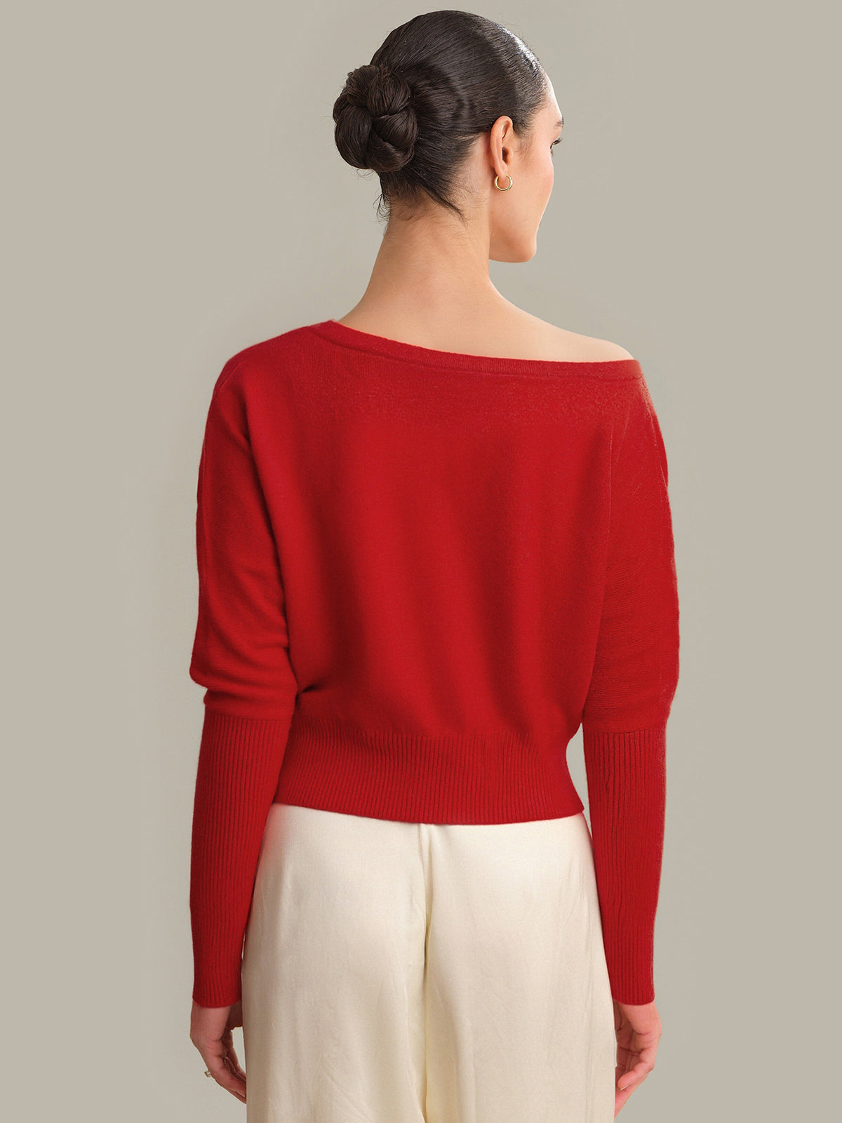 Woman wearing a red sweater with a neutral background