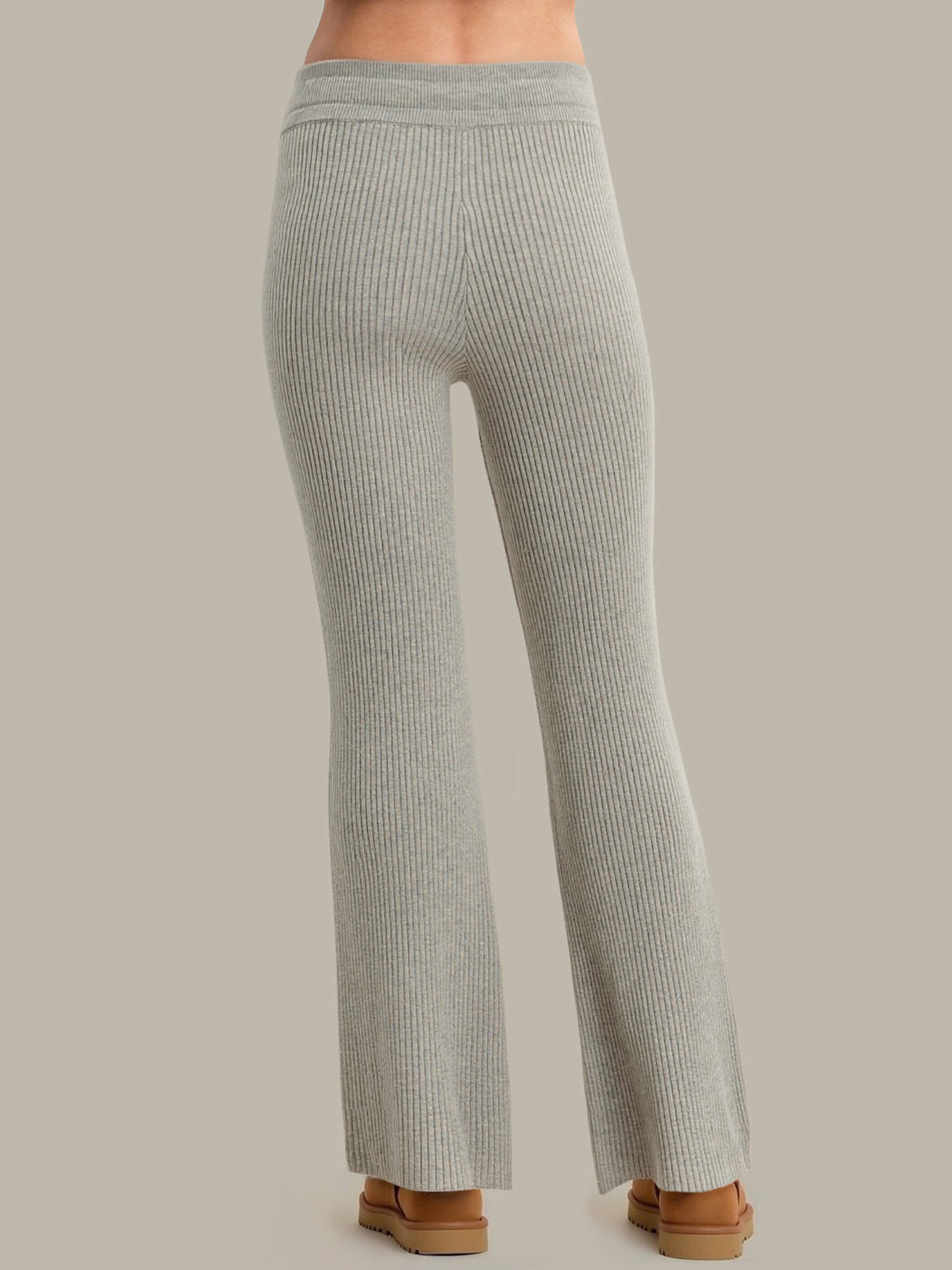 Gray ribbed pants worn by a person on a neutral background