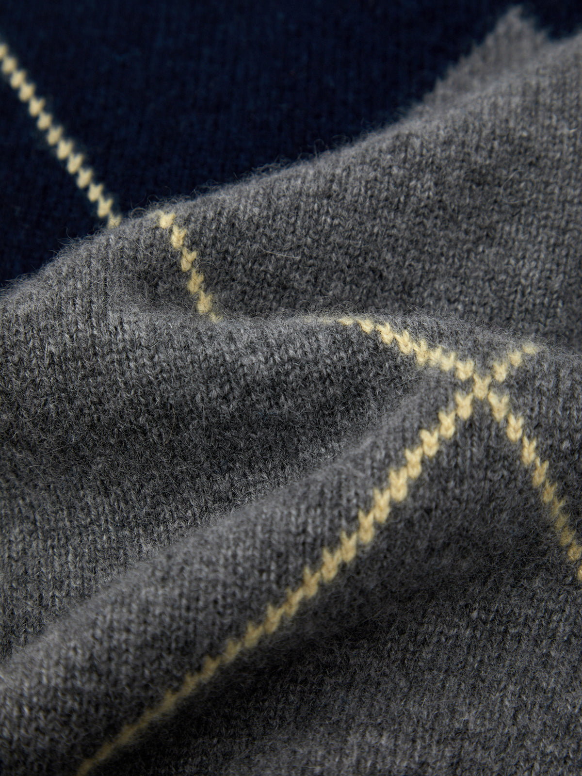 Close-up of gray fabric with yellow checkered pattern