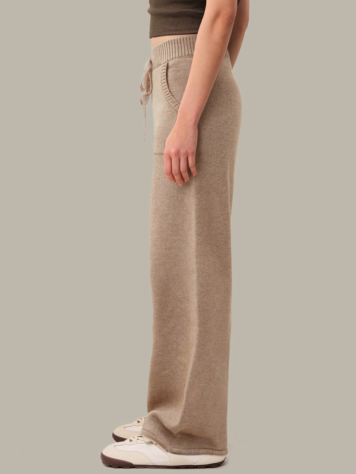 Beige lounge pants worn by a person on a plain background