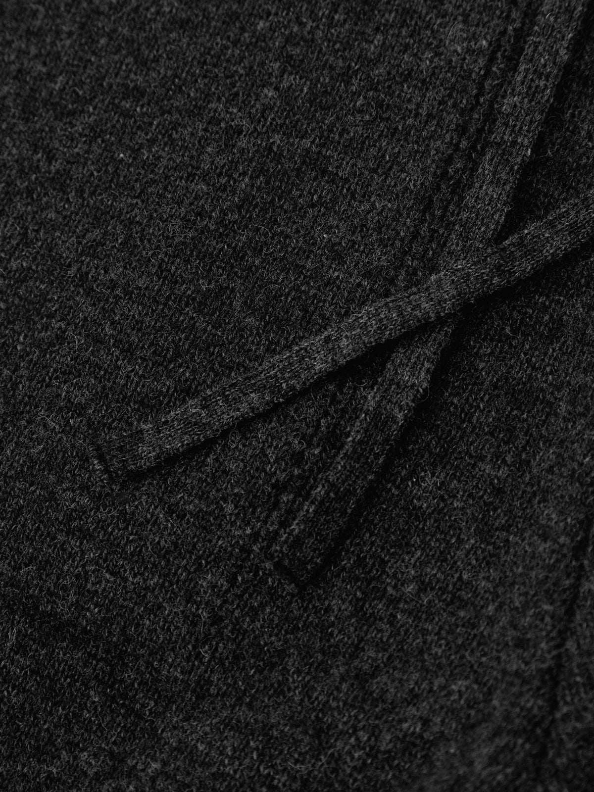 Close-up of dark gray fabric with a subtle pattern