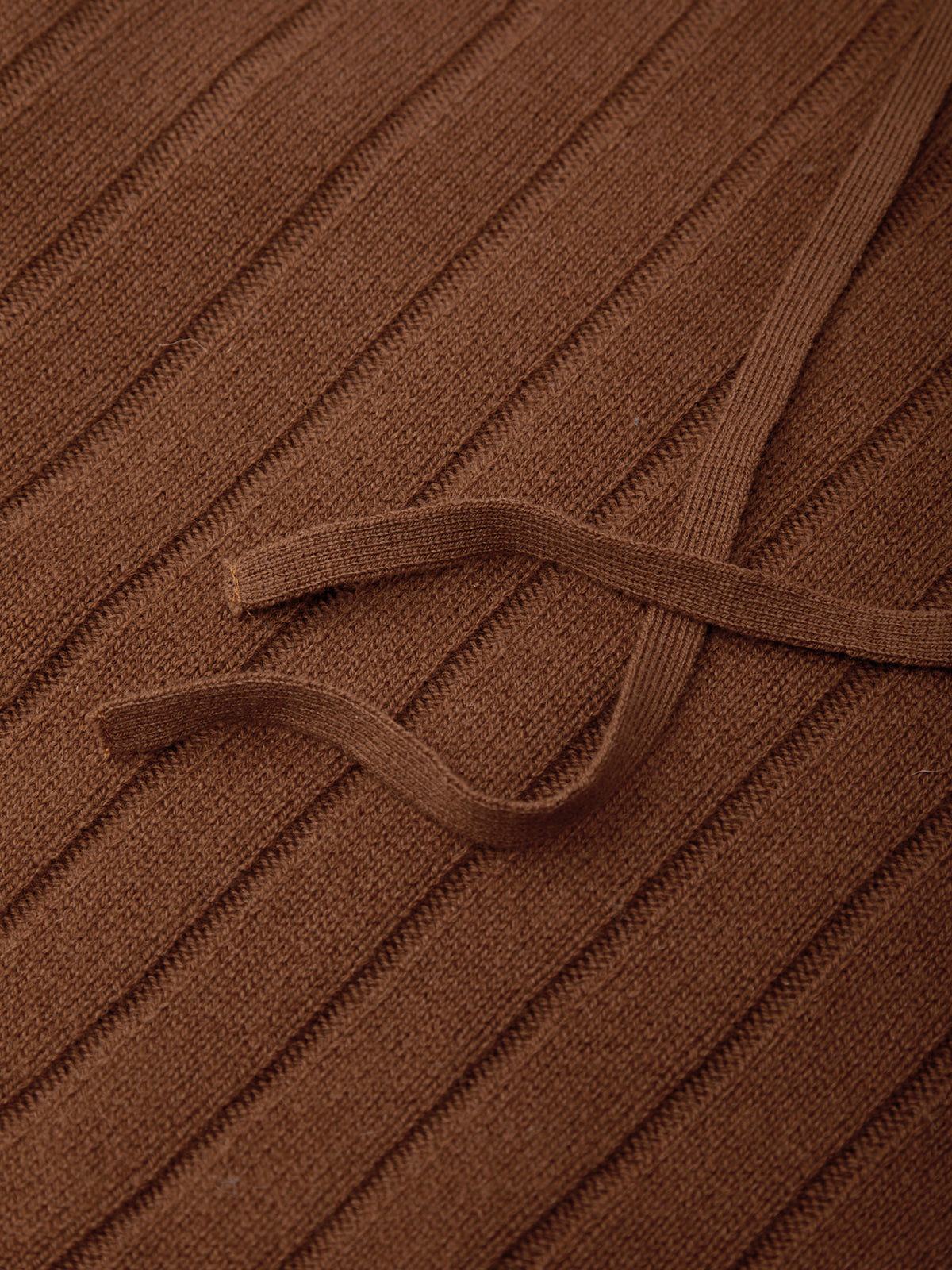 Close-up of brown ribbed fabric with a strap