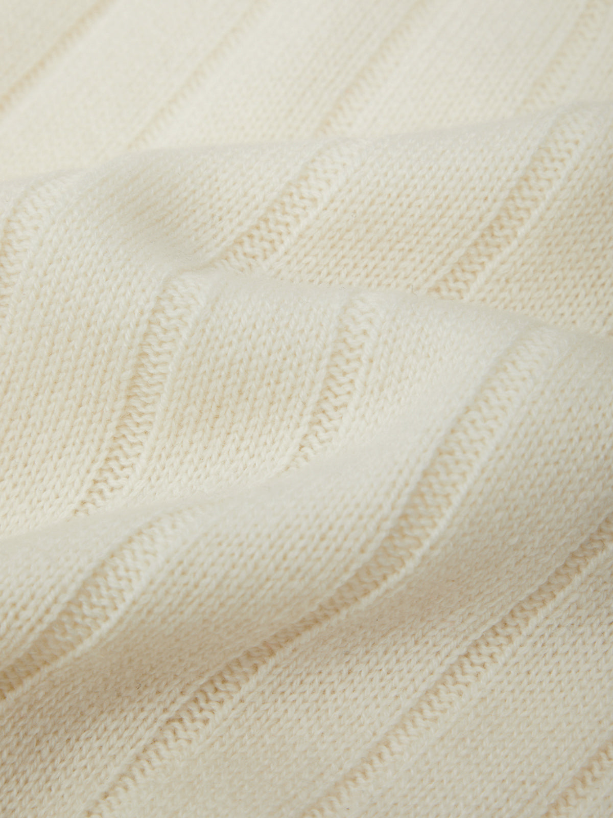 Close-up of a textured cream fabric with a subtle pattern