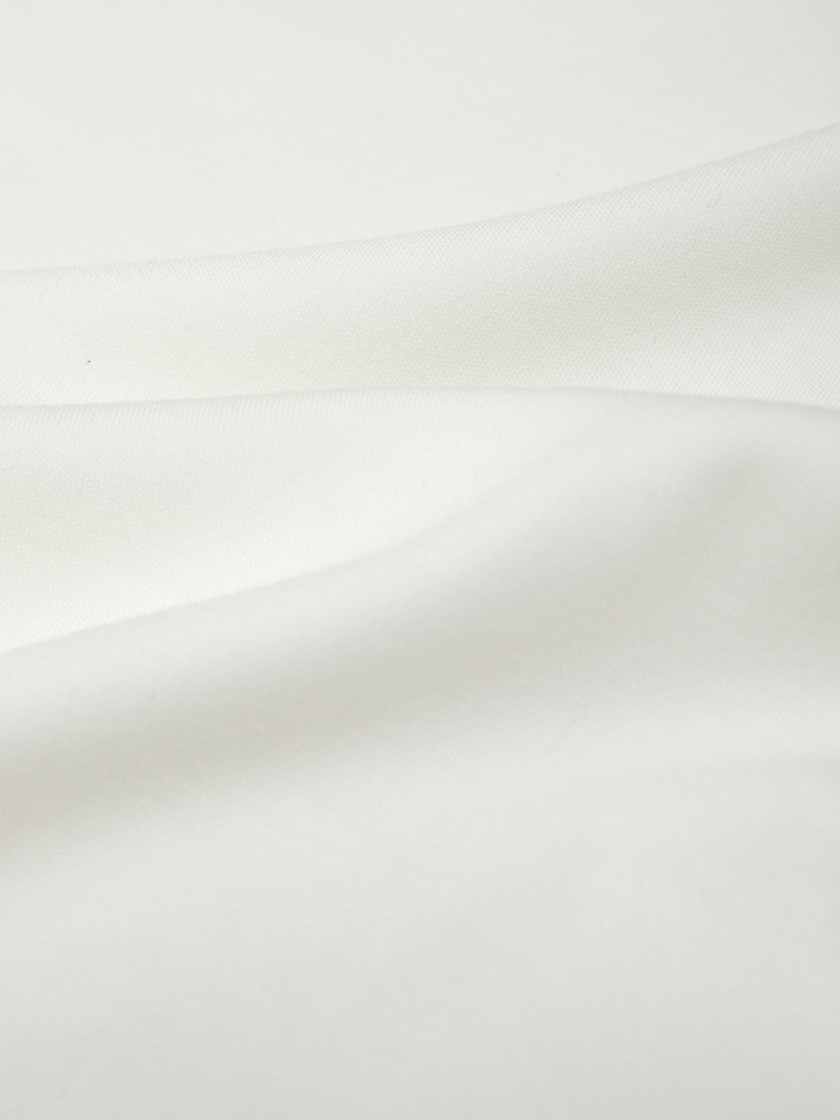 Close-up of a white ceramic tile with a subtle gradient