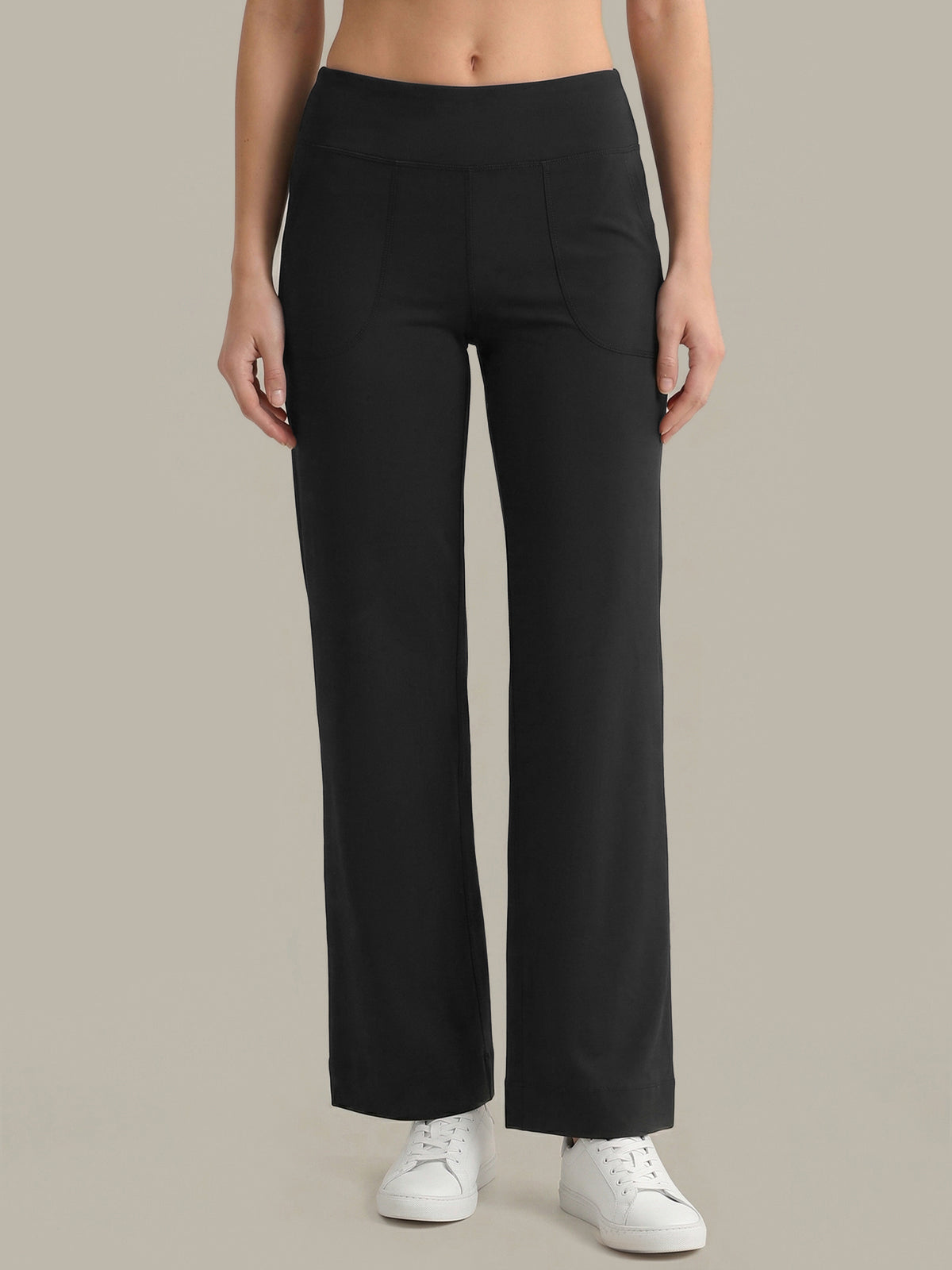 Person wearing black wide-leg pants on a neutral background