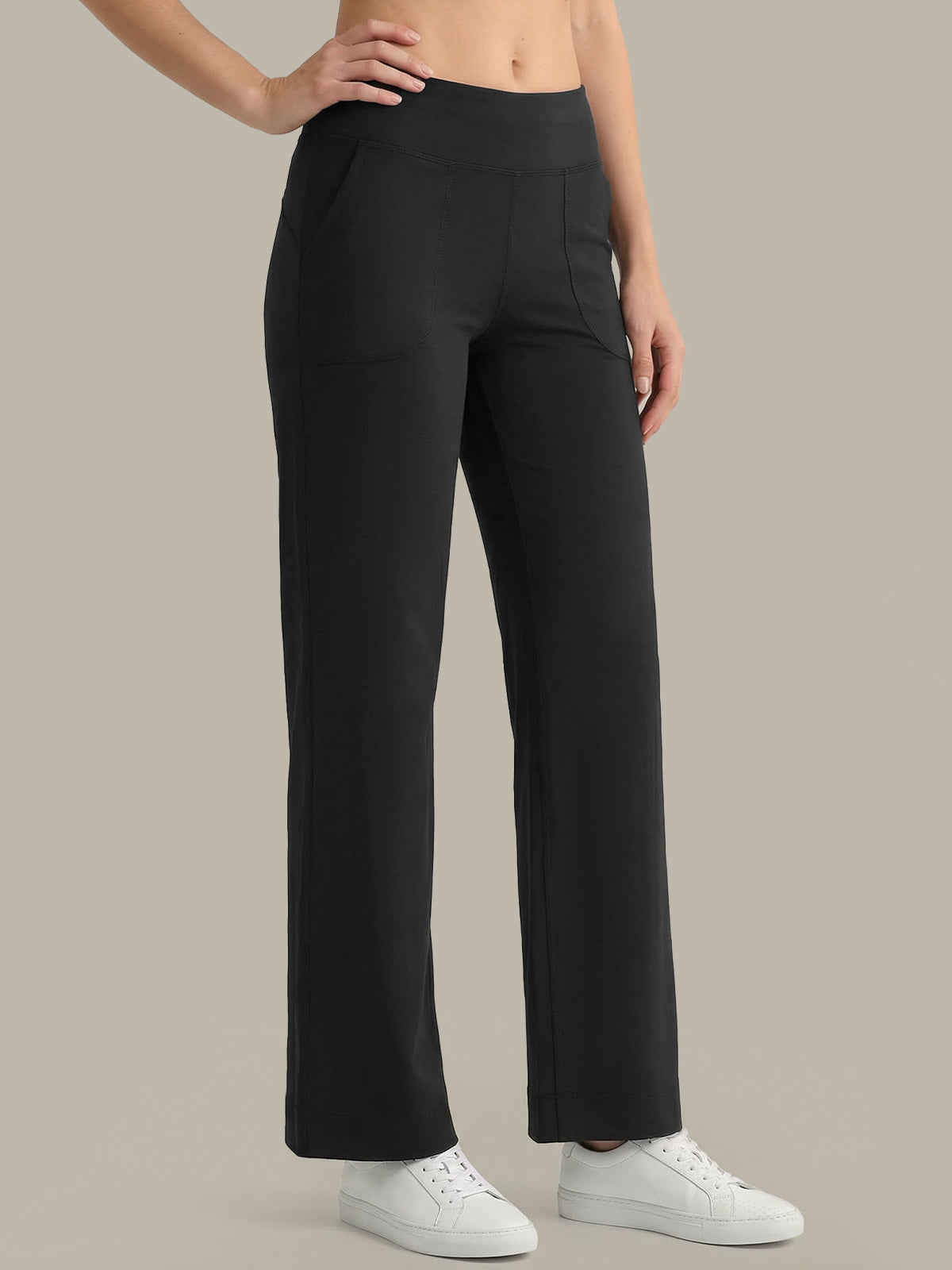 Black pants worn by a person on a neutral background