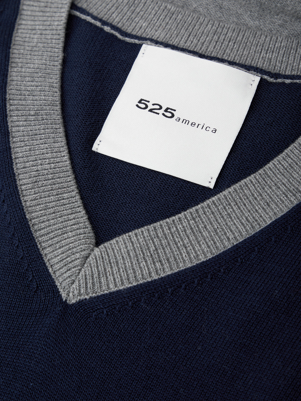 Navy sweater with a gray collar and '525 america' label.