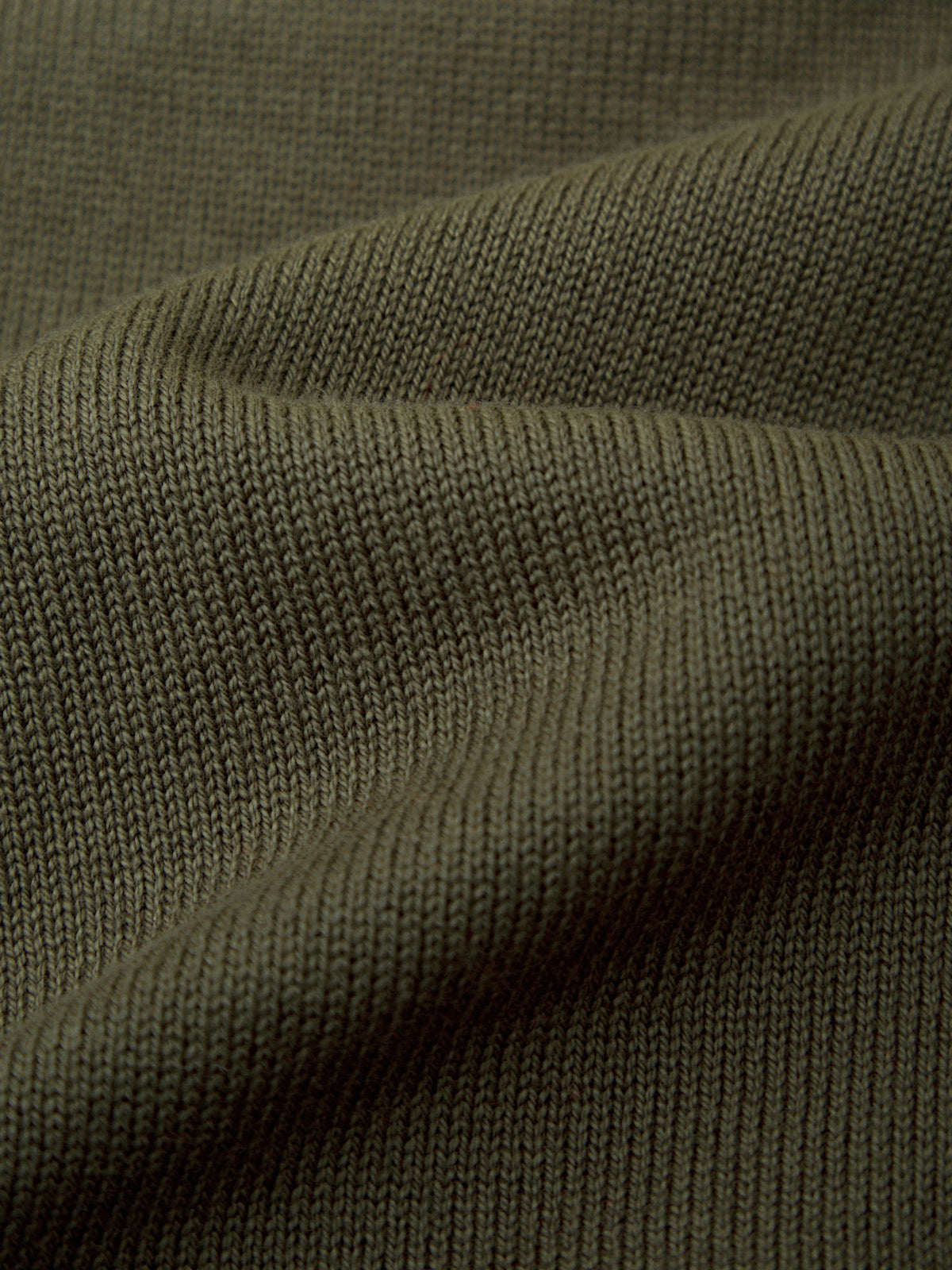 Close-up of green fabric with a ribbed texture
