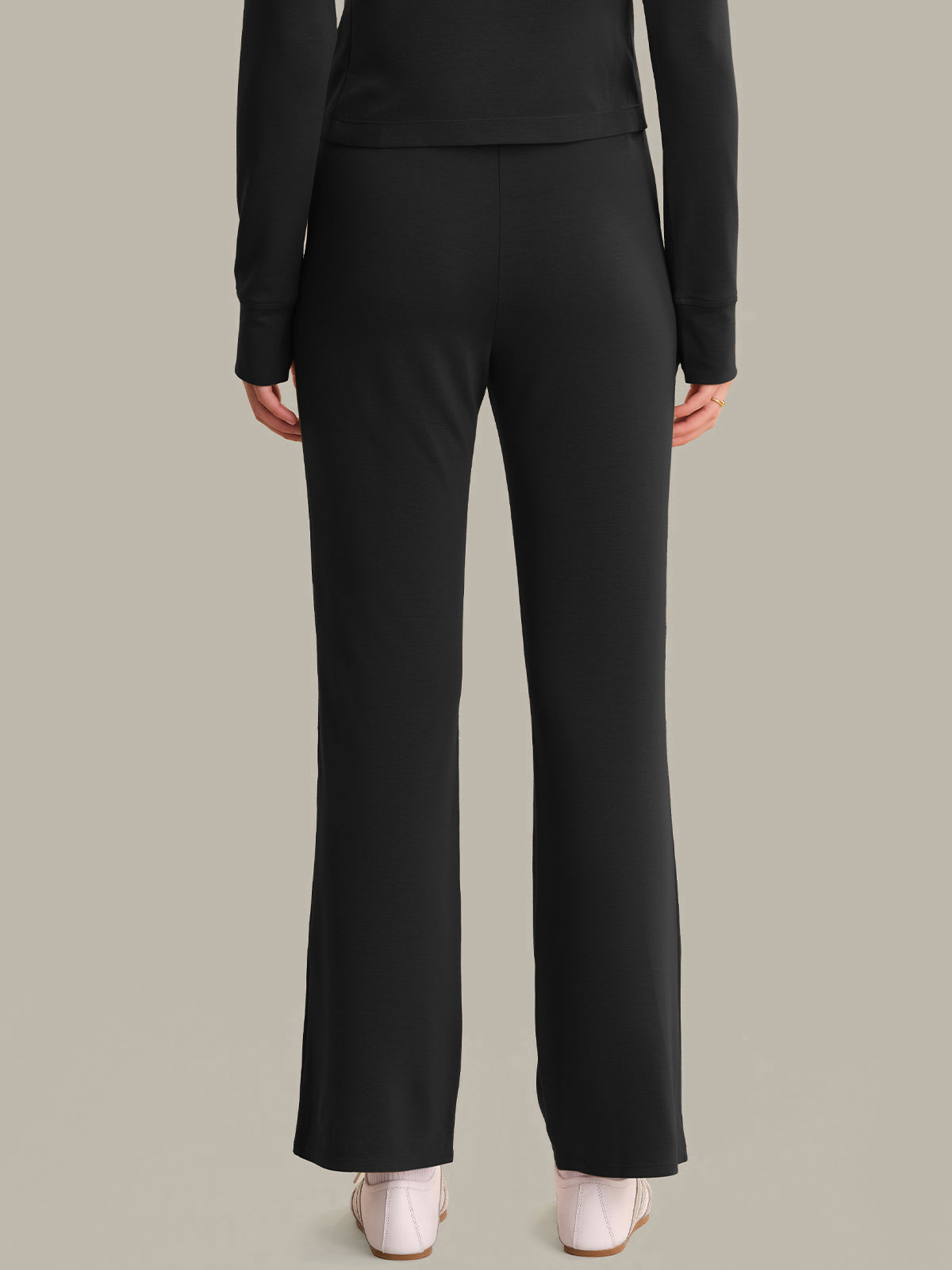 Black suit with flared pants on a neutral background