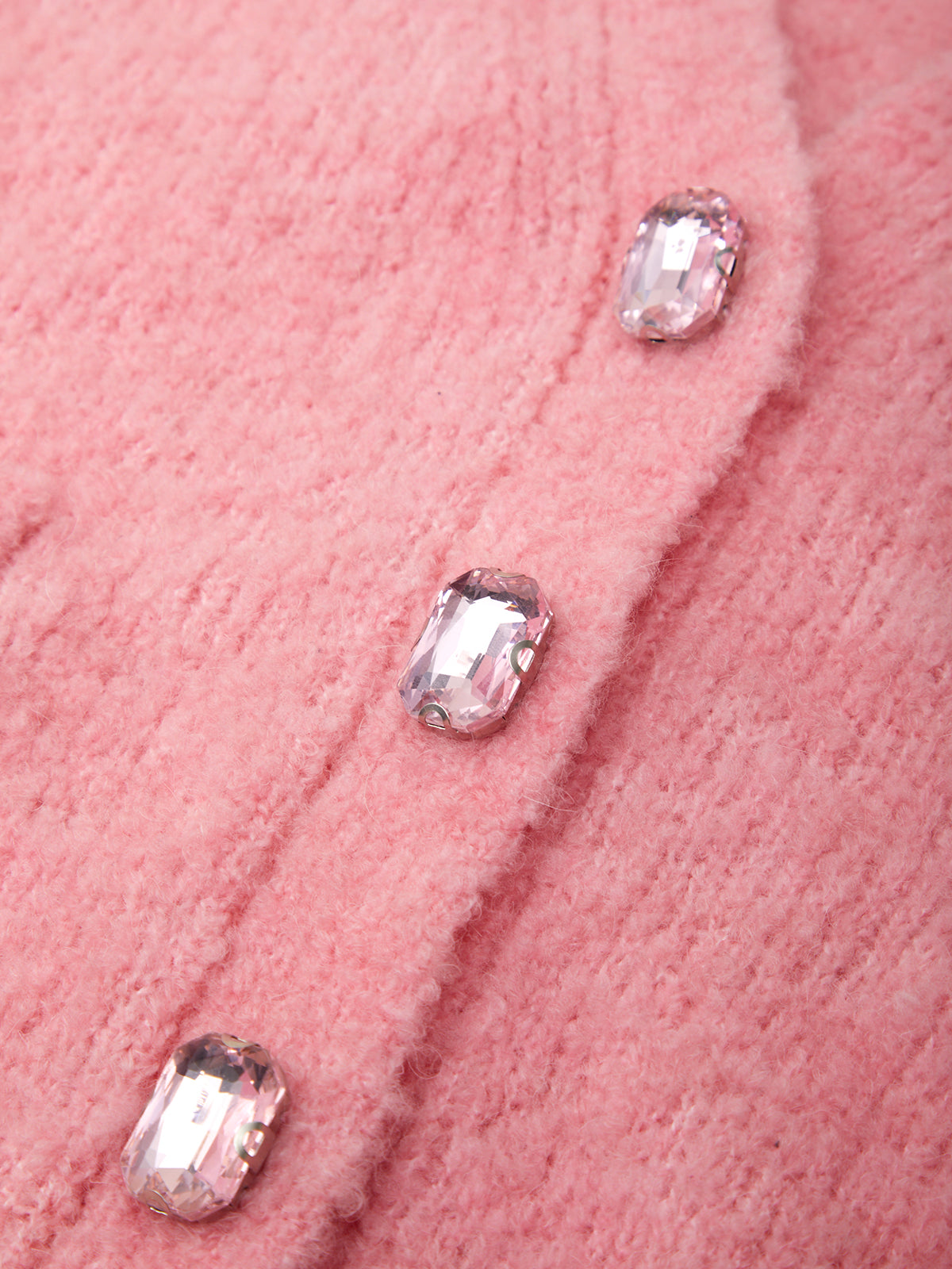 Close-up of pink fabric with crystal buttons
