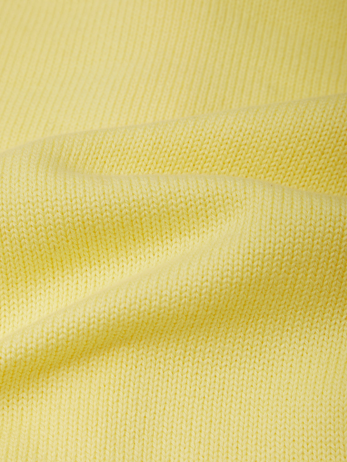 Close-up of yellow fabric with a textured pattern