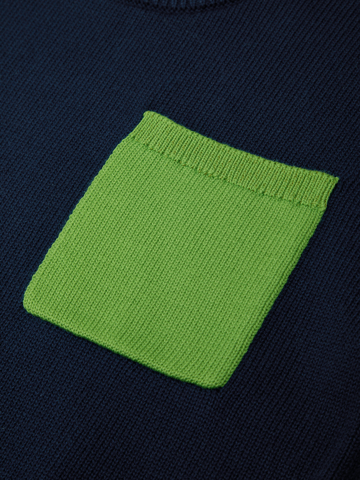 Navy sweater with a green pocket detail
