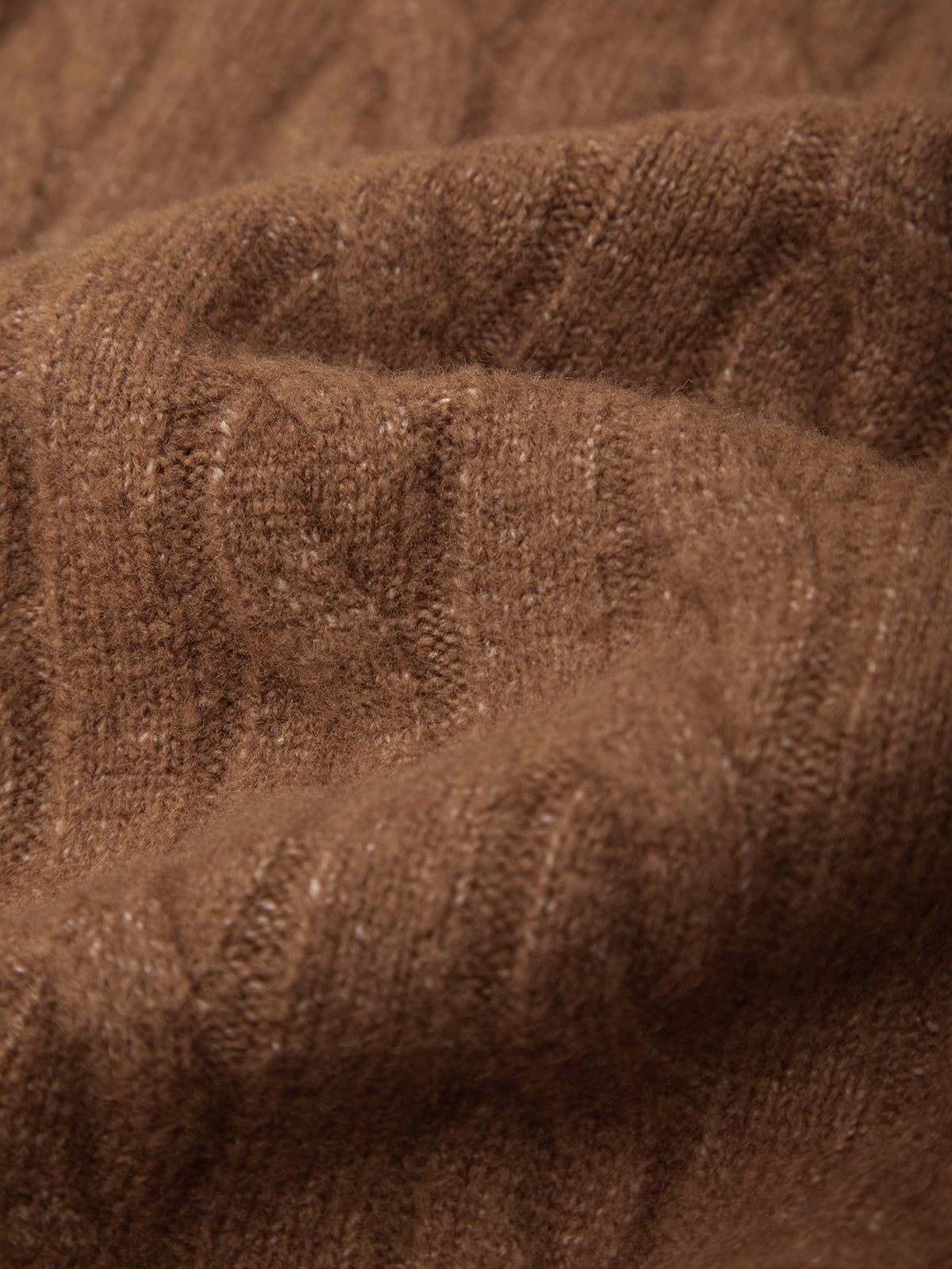 A close-up of a brown ribbed knit fabric with a soft, textured surface.