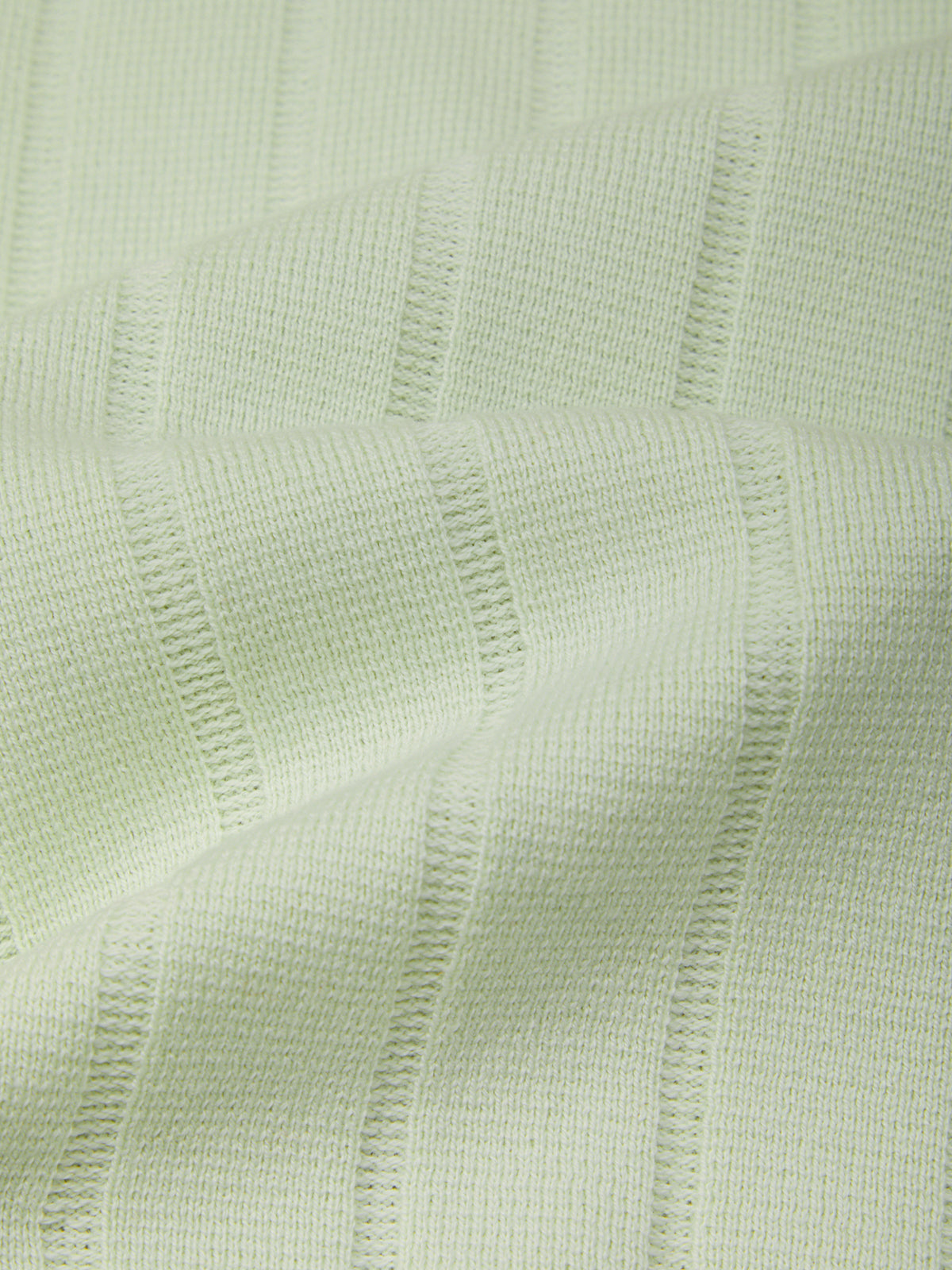Close-up of light green textured fabric