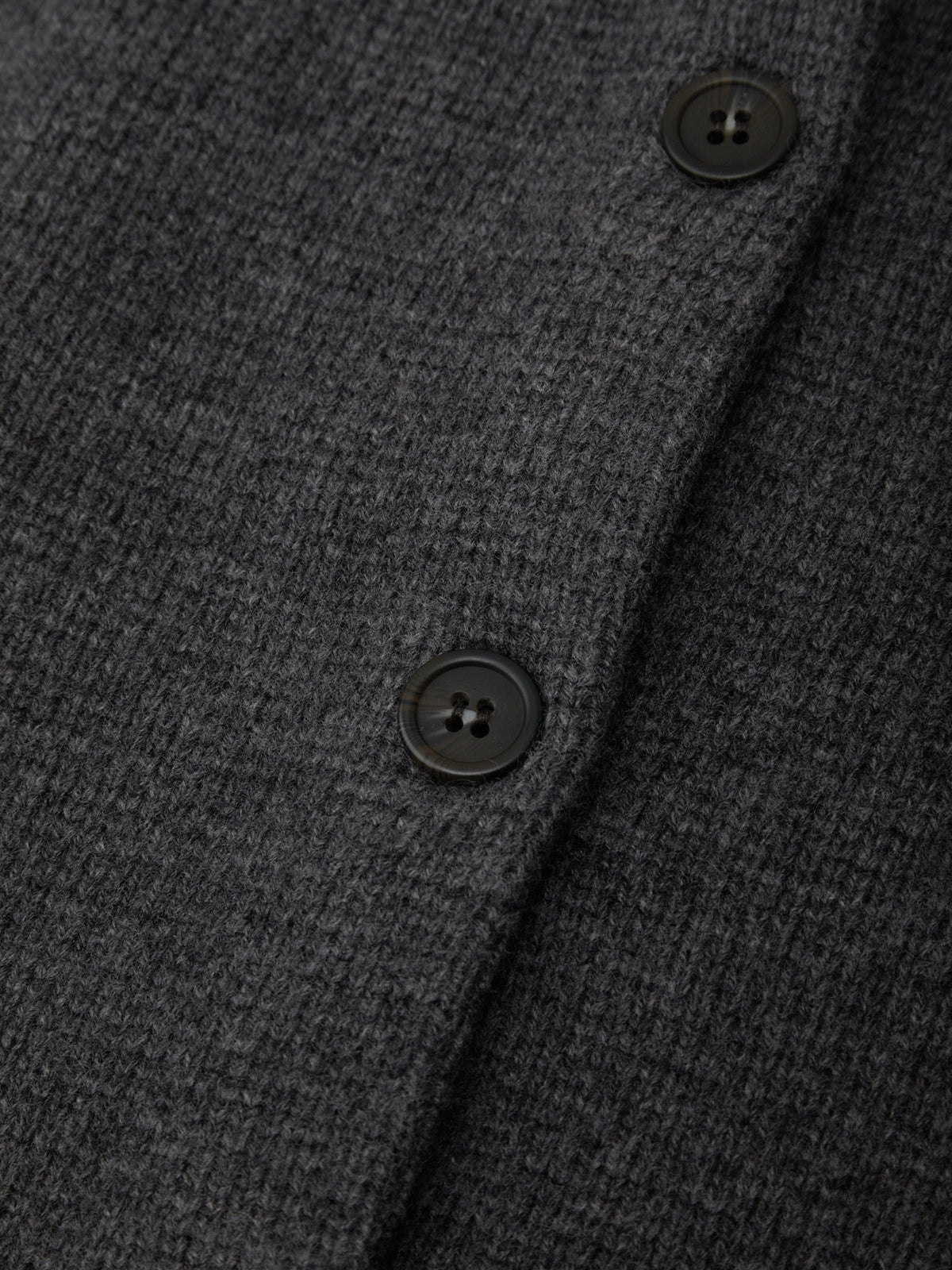 Close-up of a dark gray textured fabric with buttons