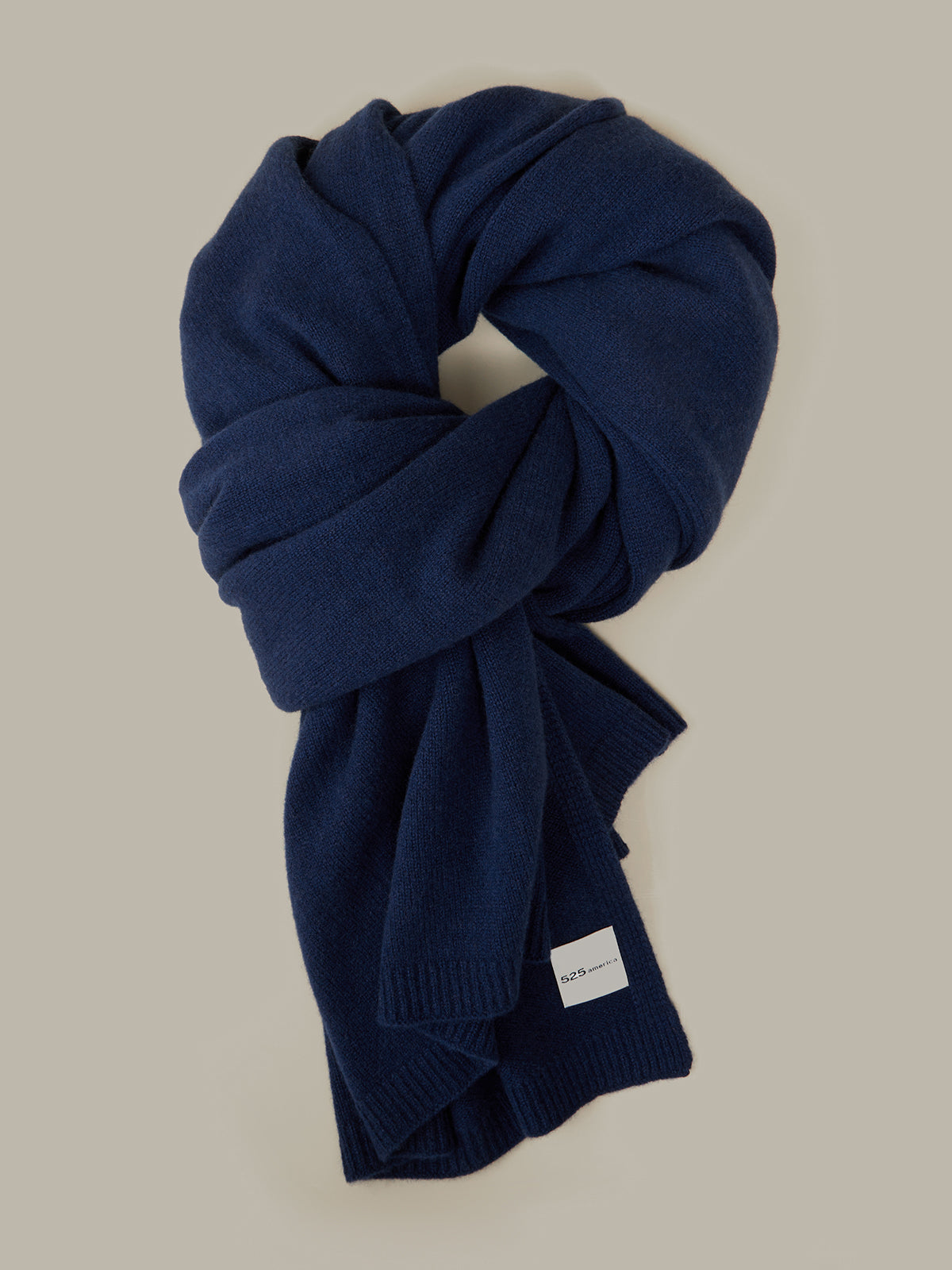 Blue knitted scarf on a beige background