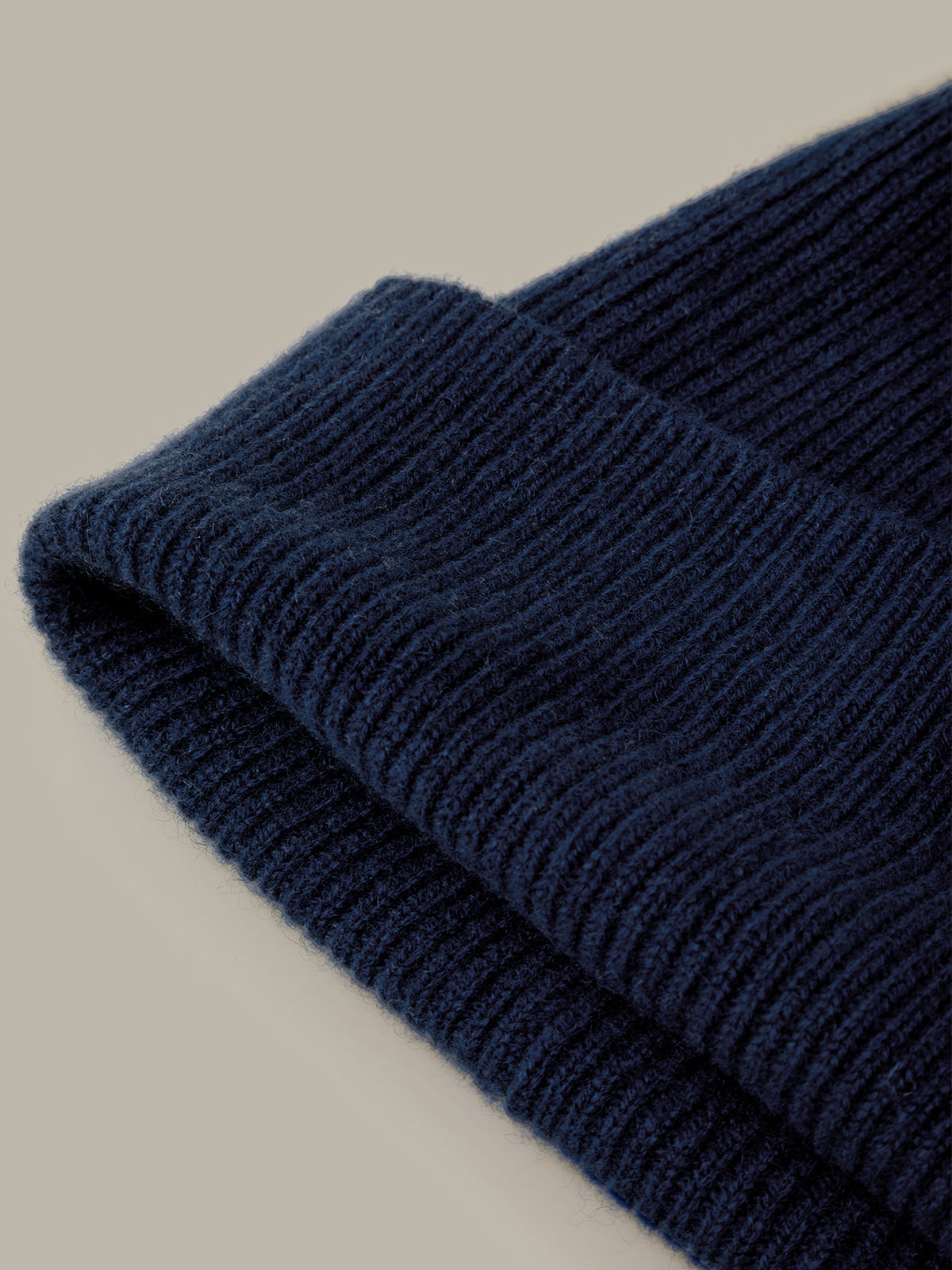 Close-up of a blue knitted fabric on a beige background