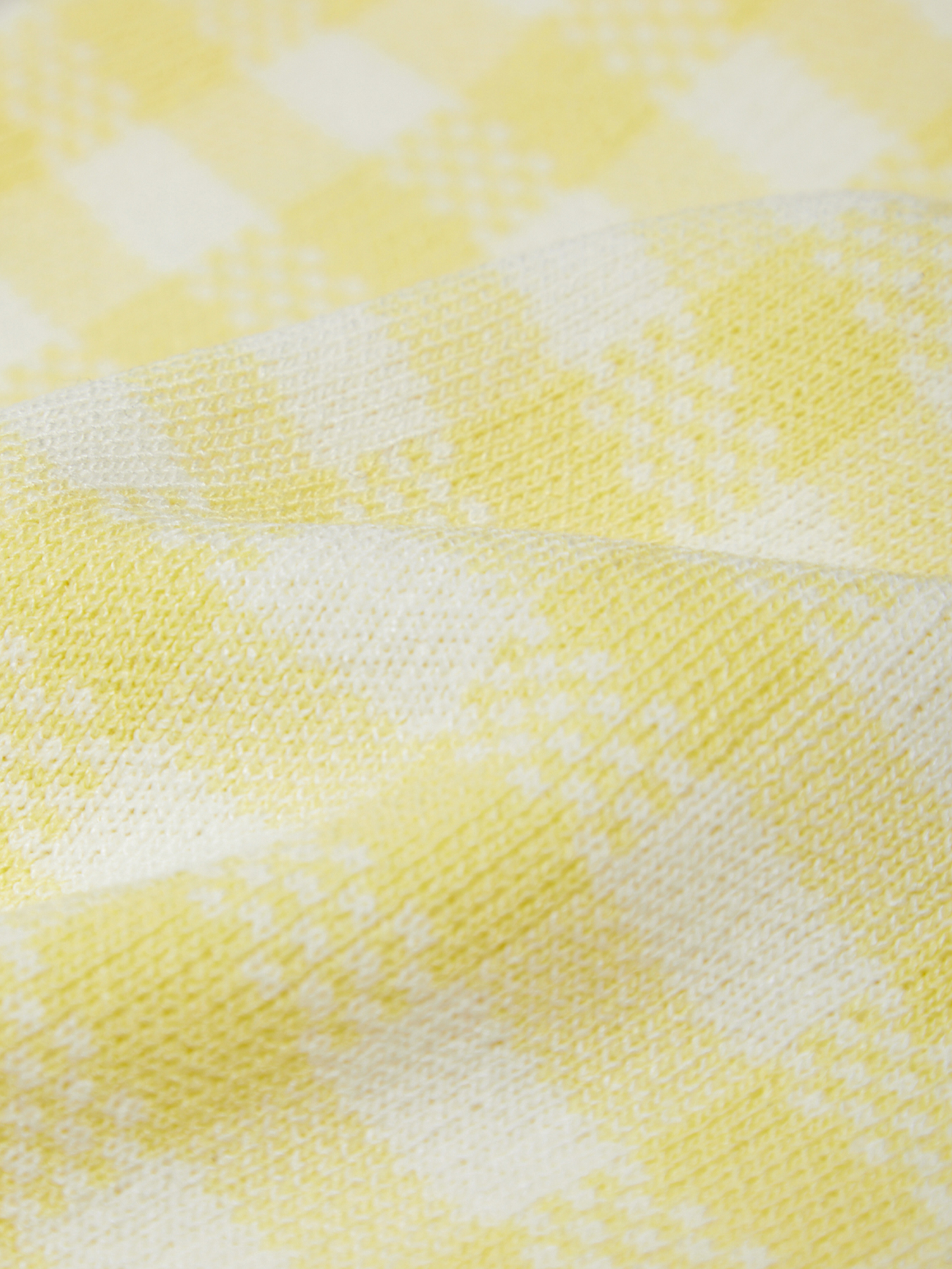 Close-up of a yellow and white checkered fabric pattern