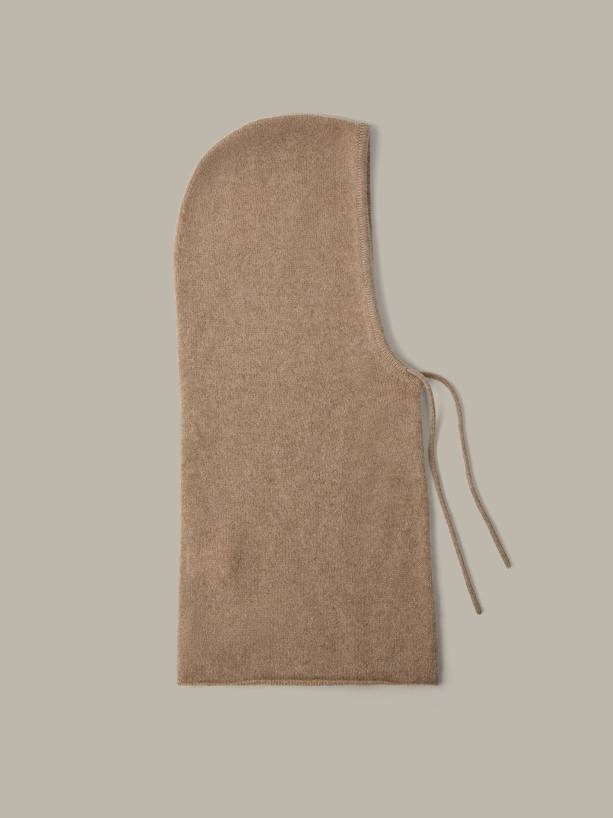 Beige hooded garment on a light gray background