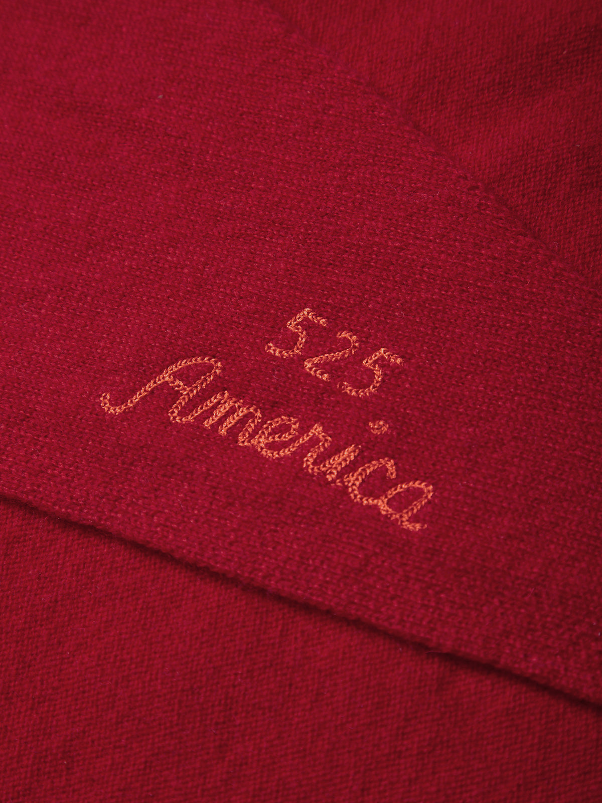 Close-up of a red fabric with '525 America' embroidered on it